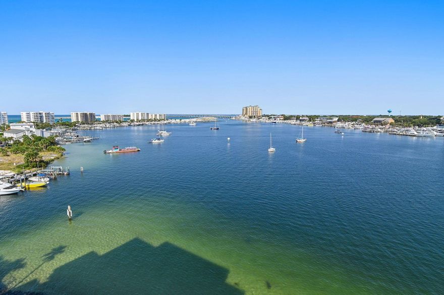 Your breathtaking waterfront story begins here, from sunrise to sunset. Perched on the top floor of a gated harborfront community, this two-bedroom, two-bath penthouse offers a front-row seat to Destin's most captivating scenery. From seasonal fireworks sparkling across the sky to the constant rhythm of passing boats, every moment feels like a postcard. For the boater, this residence is unparalleled. A private boat slip with a 16,000-pound lift -- including a walkboard -- accommodates vessels similar in size to the 31-ft. Regulator currently on site, which is also available for purchase. Rare among waterfront condos, the property features two of only six garage parking spaces located under the building, as well as a private storage unit. Two expansive balconies frame sweeping 180-degree views of the harbor, East Pass, and the gulf, offering the perfect setting for dining, grilling, or simply soaking in the sunsets. Inside, an airy open-concept layout showcases a modern kitchen with sleek white cabinetry and newer stainless steel appliances. The living room is anchored by a built-in wet bar, ideal for entertaining, while large sliding glass doors in both bedrooms and the living area open to the water, ensuring the views never fade from sight. The community itself offers a harborfront pool, boardwalk, and gated boat dock with 28 slips. Two deeded beach access points on Holiday Isle are also included. With a minimum rental term of 12 months, the community preserves its serene, residential atmosphere while offering easy proximity to beaches, dining, shopping, and the Destin Executive Airport. Blending exclusivity with unforgettable water views, this penthouse retreat offers a lifestyle as rare as the sunsets it frames.