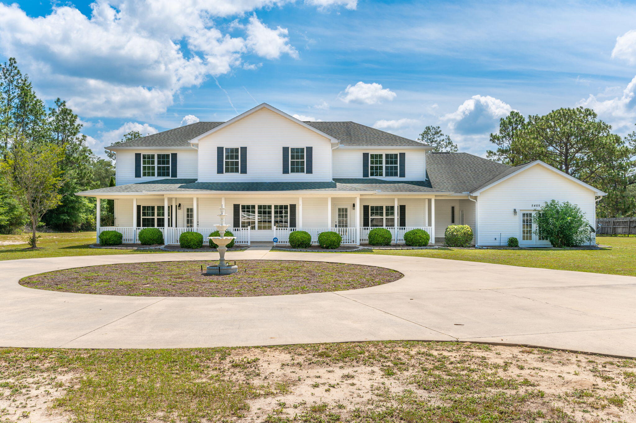 NEW ROOF ANDRECENTLY RENOVATED w/ new flooring, fresh paint, new lighting! Don't miss this sprawling 5 bd/4.5 ba estate w/ over 5,100 sq ft (heated/cooled) and situated on 2+ acres. Greeted by a circular driveway leading up to the large front porch, step inside the home to the inviting and spacious living room and semi open floor plan. The kitchen boasts solid cabinets, breakfast bar and pantry. Two oversized master suites are located on the first floor and 3 add'l oversized bedrooms are located upstairs. An additional room upstairs could be used as a 6th bedroom although there is no closet. A separate front entrance to the home leads into what has been used as both a workshop and large office space, but has endless possibilities...has a bathroom and would make a great Mother-In-Law suite