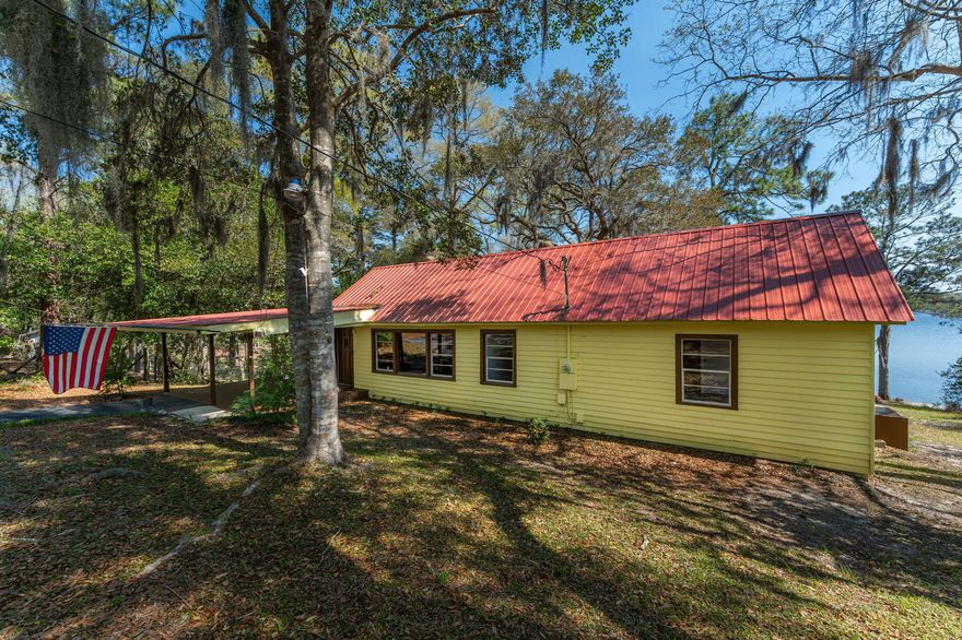 Welcome to The Lake House, a 1940's Retreat on Juniper Lake! Step into a slice of history with this 3-bedroom, 1.5-bath lake house on .44 acres of pristine waterfront. This 1,144 sq. ft. gem boasts original hardwood floors and gorgeous tongue & groove walls, adding warmth and character. The attic runs along the whole length of the house and has been partially closed in for added space if needed. Wake up to breathtaking sunrises and unwind with stunning sunsets over Juniper Lake from your spacious back deck. The dock and boathouse feature solid pilings, while cypress stumps were cleared 50 feet from the dock, creating a perfect swimming and fishing oasis. Freshly painted inside and out (March 2025), this home is waiting for you to come enjoy lakefront living on its clear lake shore point. Juniper Lake is a stunning 600-acre spring-fed lake offering breathtaking views and endless outdoor recreation. Whether you're a fishing enthusiast, a boating lover, or simply enjoy peaceful waterside relaxation, Juniper Lake has something for everyone! Impressive depth reaching a maximum of 234 feet. Boating Paradise: Gas-powered boats are allowed, making it ideal for exploration and recreation. Fisherman's Haven: A popular fishing spot known for bass, crappie, and bream. Natural Wonder: The largest of six natural lakes in Florida's Panhandle. Well-Maintained: Managed and preserved by the FWC. Whether you're seeking adventure or serenity, Juniper Lake is the perfect backyard paradise. Bring your boat, fishing gear, and a love for nature! For more information, visit the FWC website.