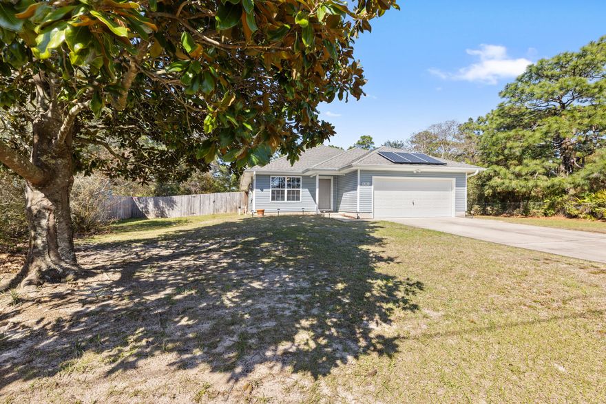 Here is an adorable 3 bedroom home in the heart of Navarre, pride of ownership is evident here.Kitchen offers a breakfast bar and is open to the living room. Laminate flooring . This layout makes cooking and entertaining easy.You'll love the Master bedroom with trayed ceilings, walk-in closet, Master bath with wainscoting walls, double vanities, with separate garden tub. The Master bedroom has a service door to the covered patio. huge, fenced back yard with firepit. This home has solar panels to ease the cost of electricity. 5 minutes to the Navarre beach. Lots of shopping and restaurants with a short drive. Click on virtual Tour!!!!