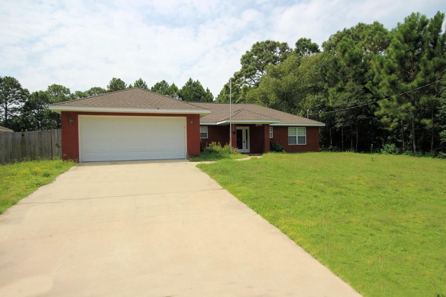 Brick front three bedroom/two bath split floor plan situated on a large lot with fenced back yard. The kitchen has custom cabinets, breakfast bar, ceramic floor, black appliances, micro-hood, and smooth top range. The foyer has an etched glass front door with matching side lite and ceramic flooring. The kitchen opens to the eating area and family room which leads to an open deck in the back yard. The master bedroom leads to the master bath which has a cultured marble whirlpool tub, and separate shower. Double car garage, fence back yard, sprinkler system on timer with private well. Great location close to school, churches, shopping, restaurants, very close to Navarre Beach and Hurlburt AFB.