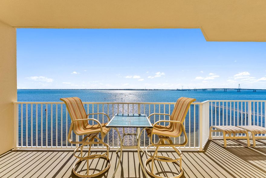 Wake up to breathtaking sunrise views over St. Andrew Bay and the Hathaway Bridge from this beautifully updated 5th-floor waterfront condo. Hurricane-rated sliding glass doors open to a spacious 200 sq ft balcony, creating the perfect indoor-outdoor retreat for morning coffee or evening relaxation. Located in the gated Hibiscus by the Bay community, this home blends coastal views with modern updates and resort-style amenities. Inside, the condo offers a bright and welcoming space with crown molding and updated flooring throughout, creating a clean coastal feel that complements the waterfront setting. The kitchen has been tastefully updated with granite countertops, stainless steel appliances (2021), and brand-new cabinetry, providing both style and functionality for everyday living or entertaining. The primary suite overlooks the bay and features private balcony access along with a beautifully remodeled bathroom complete with a step-in shower, jetted soaking tub, double vanity, and walk-in closet. Additional recent upgrades include a new HVAC system (2023), hot water heater (2023), and washer and dryer (2024), offering peace of mind for years to come. Situated on a private gated 10-acre peninsula with its own marina, Hibiscus by the Bay offers a peaceful bayfront lifestyle without the turnover of short-term rentals. Residents enjoy two swimming pools, tennis and basketball courts, dog walking areas, a fire pit, a 500-foot fishing pier, and a clubhouse. Nearly $7 million in community improvements along with reduced HOA fees have further elevated this sought-after waterfront community. A serene waterfront retreat located just minutes from the world-class beaches, dining, and entertainment of Panama City Beach.