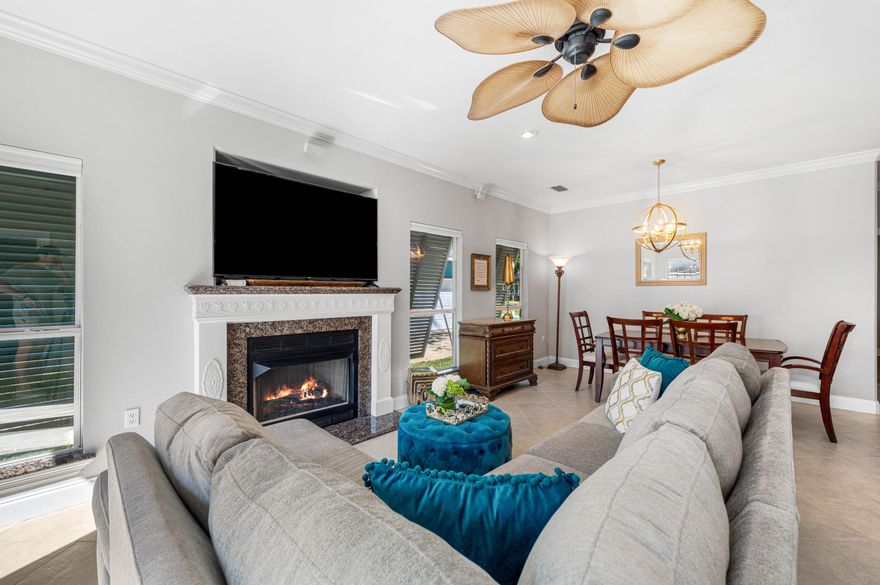 Tucked beneath a canopy of majestic oaks just steps from the bay, this beautifully crafted 4-bedroom, 3.5-bath home blends timeless Southern charm with thoughtful updates and inviting living spaces.Step inside to discover a sun-drenched family room anchored by a cozy fireplace, where oversized windows frame views of the lush courtyard beyond. The open floor plan flows seamlessly into the gourmet kitchen, showcasing granite countertops, rich cherry cabinetry, full granite backsplash, and a breakfast bar ideal for casual meals or morning coffee. Designed for modern living, the home features two primary suites on the main leveloffering exceptional flexibility for multi-generational families or guests seeking privacy. The luxurious primary retreat includes a double vanity, jetted soaking tub, and separate walk-in shower. Upstairs, two additional bedrooms share a full bath, both featuring charming Juliette balconies perfect for savoring morning breezes.

Quality craftsmanship shines throughout: a solid mahogany front door, crown molding, classic Bermuda shutters, and a new metal roof ensure both beauty and durability. Outside, the property truly captivates with professionally landscaped grounds, a fenced backyard, and a New Orleans-style gated courtyard complete with fountainan enchanting space for al fresco dining or quiet relaxation.

The generous lot provides room to roam, while the two-car garage features a separate workshop and walk-in attic storage for all your needs. Nestled near Mack Bayou, this peaceful retreat offers Old Florida tranquility yet remains minutes from Ascension Sacred Heart Hospital, Grand Boulevard's vibrant shopping and dining and the sugar-white beaches of the Emerald Coast.