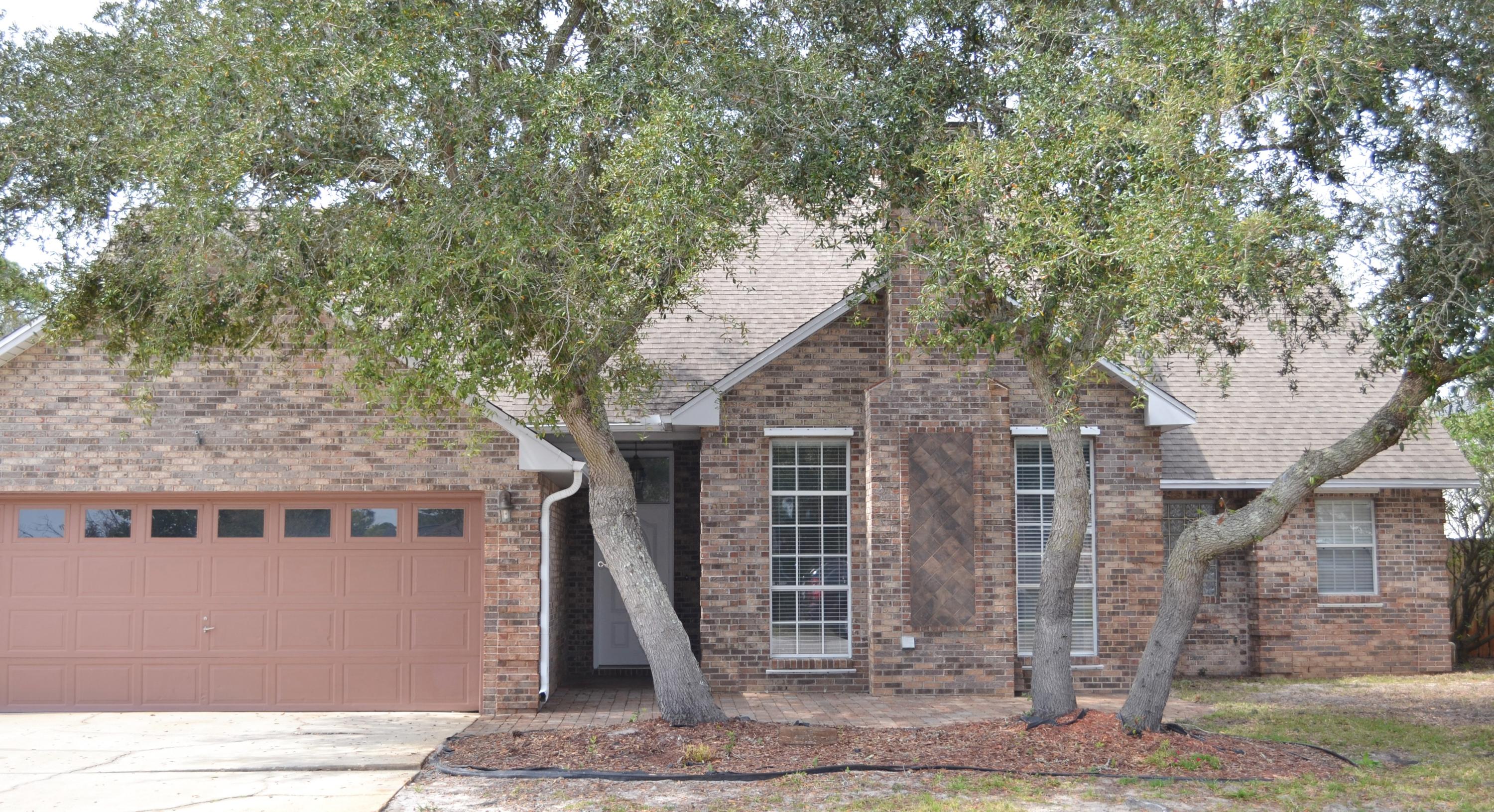 Custom Built brick home in the heart of Destin! Tiled floors throughout living space, high ceilings, fireplace and mirrored wet bar. Granite throughout a spacious kitchen. Large master suite with cultured marble double vanity, separate shower, Jacuzzi tub and huge walk in closet. Covered back patio. HOME WARRANTY AVAILABLE! Backs up to a green space, close to shopping, restaurants and fun, NO HOA FEES!