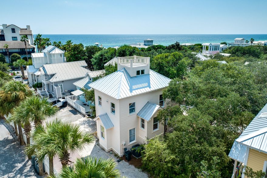 Tucked along Seaside's cherished Rosewalk and just steps from the town center, 54 Robert's Way is a masterfully redefined residence that blends architectural history with modern refinement. Originally constructed as one of the very first spec homes to introduce the Seaside vision, this property has been fully reimagined through a comprehensive renovation completed in 2023. Every detail of the home has been curated with intentionprofessionally designed with a clean, coastal-modern aesthetic that feels both timeless and elevated. The main level offers a private owner's suite with a newly constructed full bath, along with a spacious bunk room and additional full bathroom.

Upstairs, a soaring second floor delivers volume and natural light, housing a brand-new designer kitchen, wet room-style bath, dining area, and an airy living space that opens to a treetop balcony overlooking the lush Rosewalk green space. The third-floor loft, complete with a twin trundle and peek-a-boo Gulf view, adds versatility and charm.

New systems throughoutincluding all new appliances and HVACensure effortless living. Moments from Seaside's iconic town square, world-class dining, boutique shopping, and the sugar-white sands of 30A, 54 Robert's Way offers a rare opportunity to own a piece of the community's legacycompletely redefined for modern coastal living.