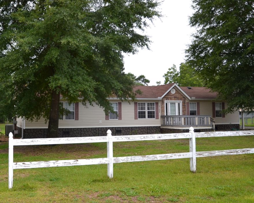 Acreage close to town! Road-to-road-1.76+/- Acres with plenty of room to park all of your TOYS! 1,800+/- sq.ft. open floor plan home ready for the new owner! And...the Seller is offering a 1 Year Home Warranty and $2,000 towards closing costs! Covered RV parking and electrical hook up for your RV, 4 bay detached carport with workshop area located in the fenced back yard; AND an oversized 57 x 12 covered patio on the back of the home perfect to enjoy your PRIVATE wooded back yard! 3 Bedrooms, 2 Bathroom home with a fireplace and fully equipped kitchen! SCHEDULE YOUR SHOWING TODAY! Master Suite has a double vanity, whirlpool tub, walk-in-closet, and separate shower. Two additional bedrooms share the 2nd Full Bathroom. Kitchen has stainless appliances, island, pantry, and tons of cabinets