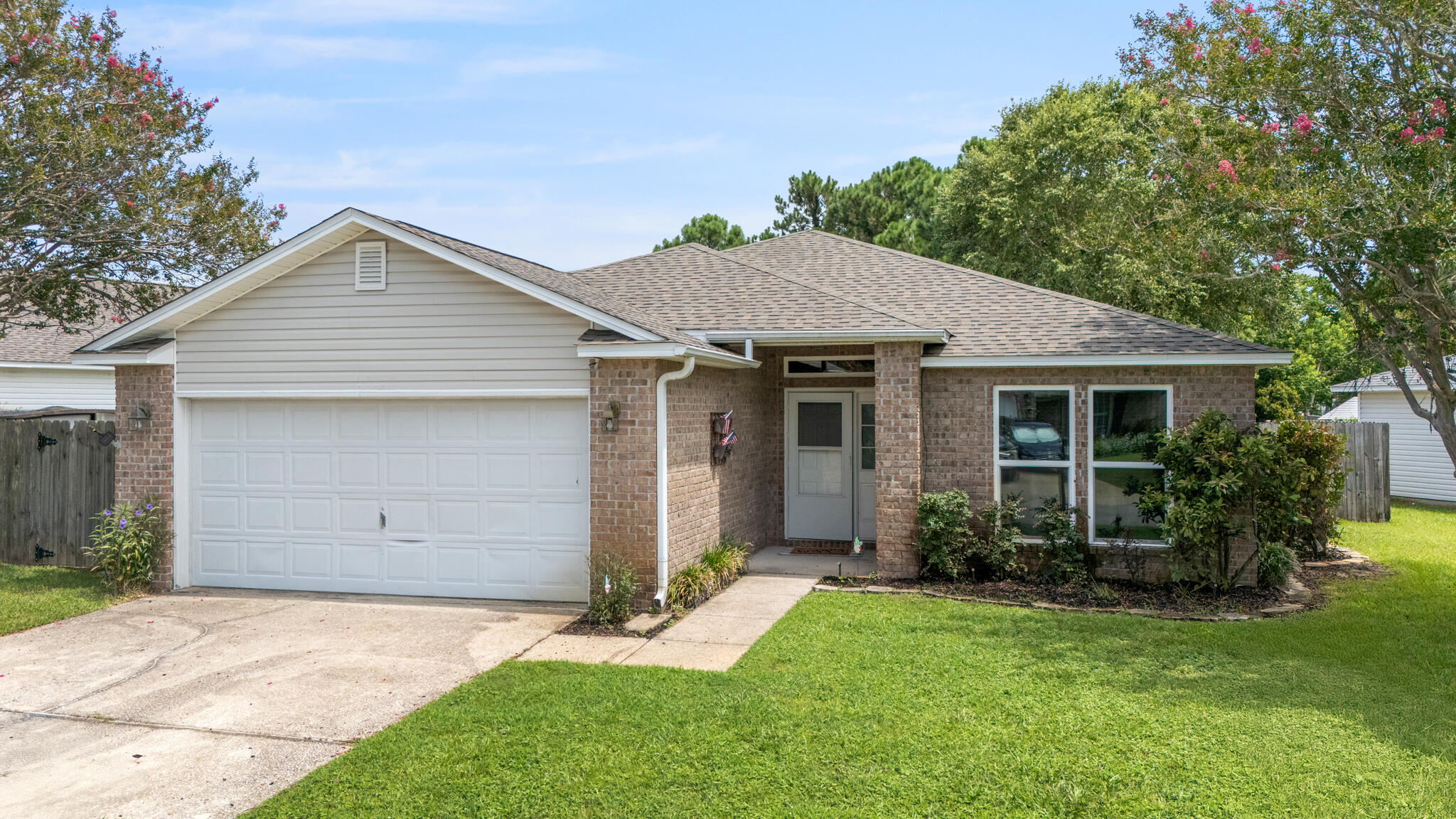 Tucked away in the quiet, family-friendly neighborhood of Hidden Shores, this beautifully maintained 3-bedroom, 2-bath home offers a rare blend of tranquility and convenience--plus a stunning lakefront setting that makes everyday living feel like a retreat. Step inside to an open and inviting floor plan where the living, dining, and kitchen areas flow seamlessly together. Oversized windows frame views of the lake and its peaceful fountain, filling the space with natural light. The kitchen is both stylish and functional, featuring granite countertops, a sleek glass tile backsplash, a new Frigidaire refrigerator, and a full suite of stainless steel KitchenAid appliances all less than five years old. A wraparound hop-up breakfast bar invites conversation, while a spacious pantry and indoor laundry room add to the home's everyday ease.
Enjoy peace of mind with major upgrades already taken care of, including a 2020 roof, impact-rated windows and doors installed in 2022, a whole-home drinking and water filtration system, and a brand-new hot water heater (2025). The primary suite is a true retreat with a large walk-in closet and a beautifully remodeled ensuite bath that includes solid-surface double vanities, a jetted garden tub, and a separate tiled shower (2023). Two additional bedrooms with laminate flooring and a guest bath with quartz countertop ensure comfort for everyone no carpet in sight.
Step outside to your private backyard oasis where mature trees offer shade and privacy from neighbors. An expansive patio overlooks tropical landscaping and a picturesque lake with a lighted fountain. Follow your own gated path for direct access to the lake perfect for peaceful walks or simply enjoying the view.
Enjoy the best of both worlds: serene surroundings with convenient access to it all. Commuting is a breeze to Hurlburt Field and to NAS Pensacola.