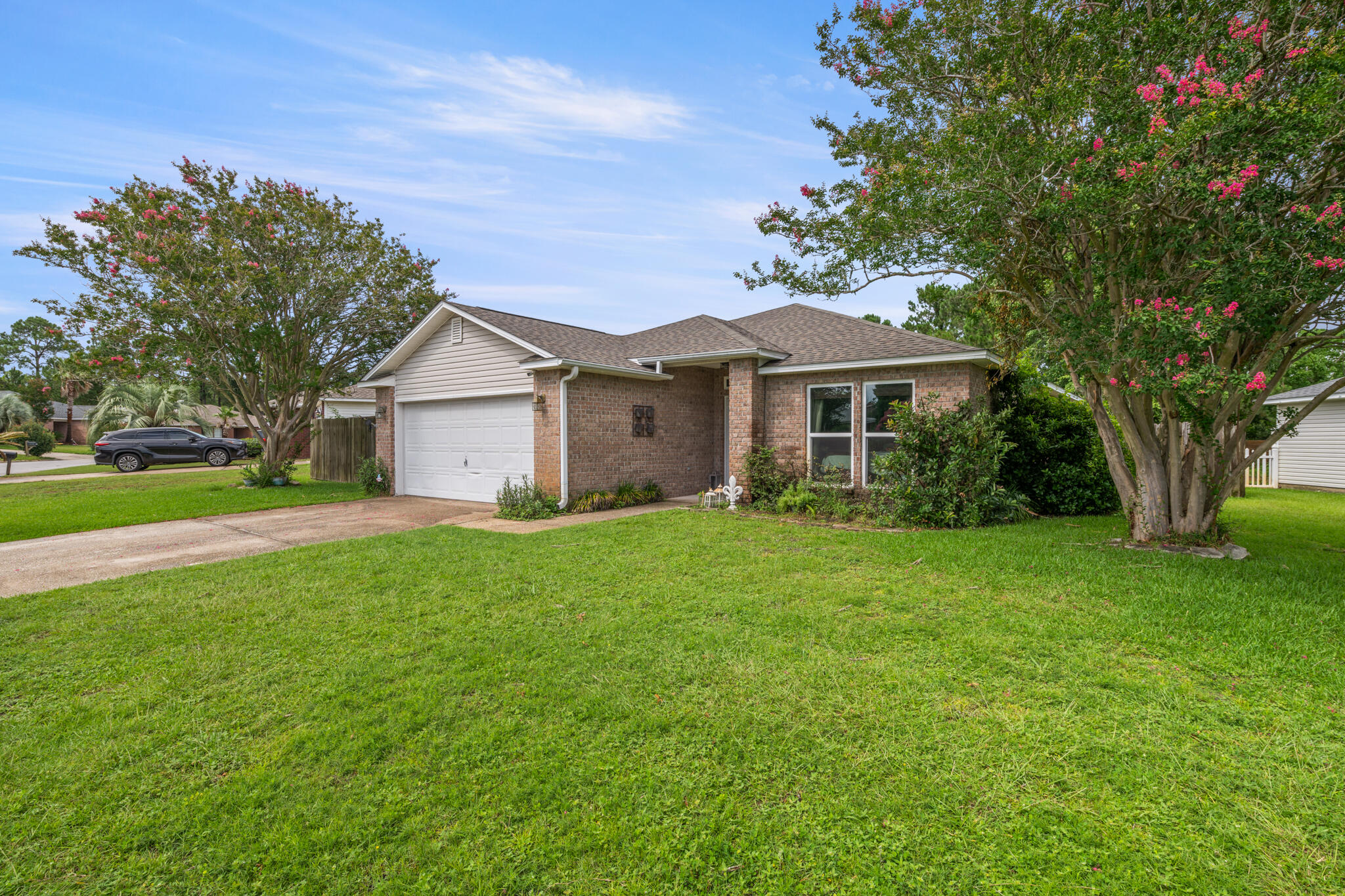 Tucked away in the quiet, family-friendly neighborhood of Hidden Shores, this beautifully maintained 3-bedroom, 2-bath home offers a rare blend of tranquility and convenience--plus a stunning lakefront setting that makes everyday living feel like a retreat. Step inside to an open and inviting floor plan where the living, dining, and kitchen areas flow seamlessly together. Oversized windows frame views of the lake and its peaceful fountain, filling the space with natural light. The kitchen is both stylish and functional, featuring granite countertops, a sleek glass tile backsplash, a new Frigidaire refrigerator, and a full suite of stainless steel KitchenAid appliances all less than five years old. A wraparound hop-up breakfast bar invites conversation, while a spacious pantry and indoor laundry room add to the home's everyday ease.
Enjoy peace of mind with major upgrades already taken care of, including a 2020 roof, impact-rated windows and doors installed in 2022, a whole-home drinking and water filtration system, and a brand-new hot water heater (2025). The primary suite is a true retreat with a large walk-in closet and a beautifully remodeled ensuite bath that includes solid-surface double vanities, a jetted garden tub, and a separate tiled shower (2023). Two additional bedrooms with laminate flooring and a guest bath with quartz countertop ensure comfort for everyone no carpet in sight.
Step outside to your private backyard oasis where mature trees offer shade and privacy from neighbors. An expansive patio overlooks tropical landscaping and a picturesque lake with a lighted fountain. Follow your own gated path for direct access to the lake perfect for peaceful walks or simply enjoying the view.
Enjoy the best of both worlds: serene surroundings with convenient access to it all. Commuting is a breeze to Hurlburt Field and to NAS Pensacola.