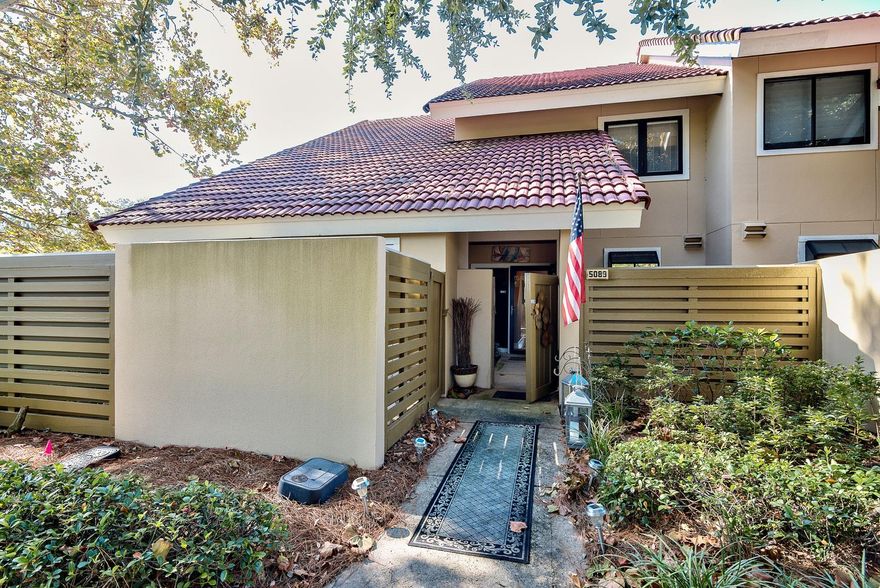 You haven't seen a Beachwalk townhome like this one! This 2 bedroom 2.5 bath home looks like a designer showhouse--- it is beautifully renovated and is conveyed with all of the furnishings and accessories ready for you to walk in and enjoy-- Take in the long view of the lake looking out to the fountain from your private patio, living room or master bedroom. The kitchen includes beautiful solid surface countertops and stainless steel appliances including a side by side refrigerator. A darkwood buffet cabinet with granite countertop adds storage and elegance to the kitchen, too.The kitchen opens to the dining room with driftwood gray rectangular table six chairs and buffet. The living area is spacious with plenty of seating to watch the 50 inch flat screen television.