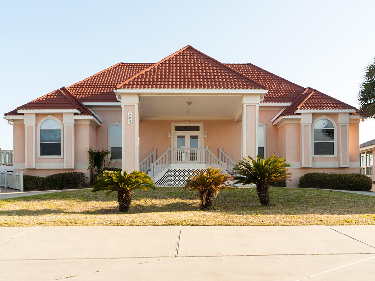 Rarely does a Gulf front home on Holiday Isle come available at such a reasonable price. Do not missing this opportunity to secure this quintessential beach home which enjoys 100 feet of private beachfront that extends to where the emerald Gulf water meets the sugar white sand. Enjoyed as a family compound for many years and as a vacation rental for the past five, this home has an established rental history. A deep covered porch on the first floor, joined by an equally deep sun deck on the second floor, are wonderful gathering places and spots to relax or sunbathe. Listen to the boats leaving East Pass and watch as seagulls and dolphins follow them. Beyond the open kitchen, living and dining room areas are windows and doors which stretch along the entire Gulf side of the home will treat