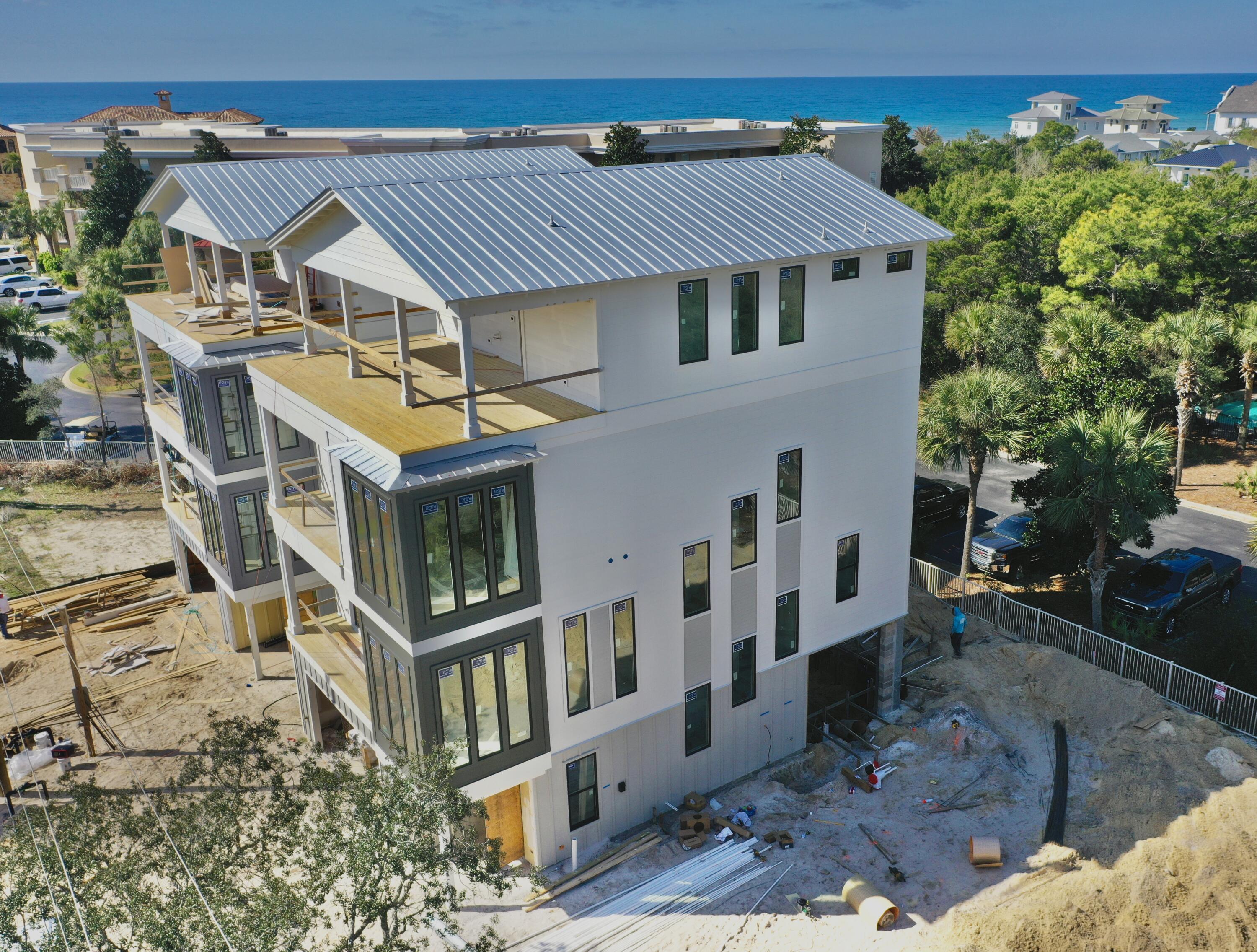 Gorgeous four-story rental dream under construction, south of 30A on Mary Street in Blue Mountain Beach. Take advantage of preconstruction pricing and add your personal touch to finishes. (May 2025 completion date) Perfect for indoor/outdoor entertaining, the first level includes a half bath and mini kitchen with a full sliding wall that opens to the pool deck. The second floor features the spacious kitchen, dining and living area, perfect for large families or parties to gather. The kitchen features Thermador appliances, a gas stove, ample counter space for serving, and a walk-in pantry. The third floor boasts a lovely master suite with a private balcony. Two guest suites with private bathrooms are also available on the third floor, one of which would be ideal for a multi-bunk room.