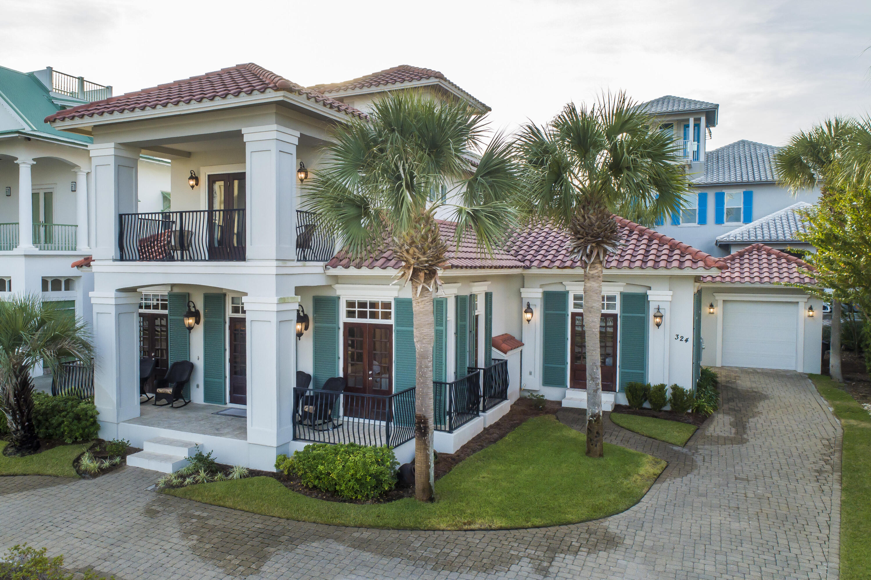 Welcome to this stunning Mediterranean-Caribbean villa in the coveted Caribe community of Miramar Beach, FL. With 4 bedrooms and 4.5 bathrooms, this home offers a spacious open concept layout and breathtaking lake views. Inside, you'll find a bright living room, kitchen, and dining area with 10' ceilings. The first-floor guest suite has a private entrance and sitting area, while the master suite provides easy access to the patio. The main kitchen features a wraparound breakfast bar and beautiful hardwood cabinetry. Upstairs, there are two guest rooms and an additional living area. The third floor offers a sitting area, office space, wet bar, and two balconies with views of the lake and Gulf. Caribe is a gated community with pools, tennis courts, and private beach access.