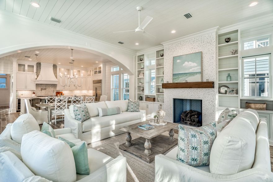 This custom designed residence in WaterSound Beach is sure to impress. The interior selections & finishes are a refined sophistication evident throughout the home. One immediately appreciates the venetian plaster walls & skillful millwork in the trim, moldings, doors & cabinetry. There is an abundance of natural light streaming through the plethora of windows which accents the white oak flooring. The screened porch has an outdoor fireplace & summer kitchen complete with vented grill & fridge and bi-fold doors which open creating a fluid space for everyone to gather. An elevator services the first two levels. A sand room with laundry & powder bath complete the first level. A private heated pool fronts coveted Puttering Park. No element has been overlooked! These upgrades set the tone for a relaxed ambience which is found throughout this unique & inspired beach home. The open living room is accentuated by the custom arch & fireplace with custom shelving. The gourmet kitchen is inviting with all of the highest end accoutrements including Wolf & Subzero appliances & wet bar, no element has been overlooked.  A junior master bedroom with ensuite is located on the first floor.  Take the elevator or head up the custom staircase to the oversized master retreat with private balcony & spa-like bath with modern soaking tub & walk-in shower.  An additional two guest bedrooms with ensuites exude a calming coastal palette. The second living space is the perfect spot for the kids & there is also a double bunk room with full bathroom. Another full laundry is located on the second level.   Enjoy the Gulf of Mexico views from the tower. Other upgrades include marble bathrooms, quartz countertops, sliding bi-fold doors & hand-crafted wood beams. Perfectly blending form & function, with a masterful use of timeless lighting, stunning fixtures & pride of craftsmanship this home will leave a lasting impression! 
 
