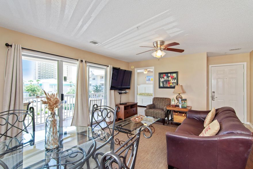 IT'S A GEM! Three bedroom, two bath completely updated second floor condo with a two minute walk to the private beach access  no streets to cross. This unit is projected to gross $25,000 annually & is approved for VA loans. Knock out kitchen with granite counter tops, new stainless appliances, pendant lights, & updated cabinets. Open split bedroom floor plan. Living room & the master bedroom both open to a spacious balcony. Beautiful neutral colors  all floors are hardwood & tile. Bathrooms are also updated with granite counter tops & decorative mirrors. There is a full-size laundry room with washer & dryer. Very nicely furnished.