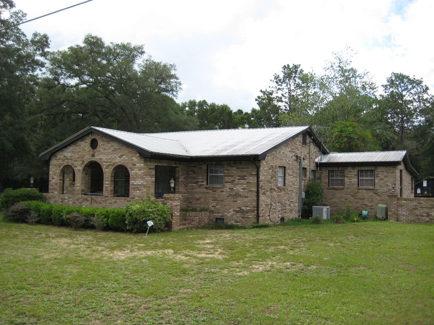 RARE FIND!!! Three bedroom and 2 bath, extremely well-kept country home on 15 beautiful wooded acres in Holt. Home features a great country kitchen with loads of counter-tops and cabinets, smooth top range and side-by-side refrigerator. Large dining and living room with beautiful and original hard wood floors. All 3 bedrooms feature these same great hard wood floors and are very roomy compared to modern homes while still featuring a split bedroom design. Large and comfortable family room in the back of the house with a cozy fire place. ---- Outside you will find a great workshop with all of the bells and whistles, including a window unit in the front shop. Shop is truly a wood-worker or mechanics dream. All on 15 pristine acres with mature pines and plenty of wildlife!