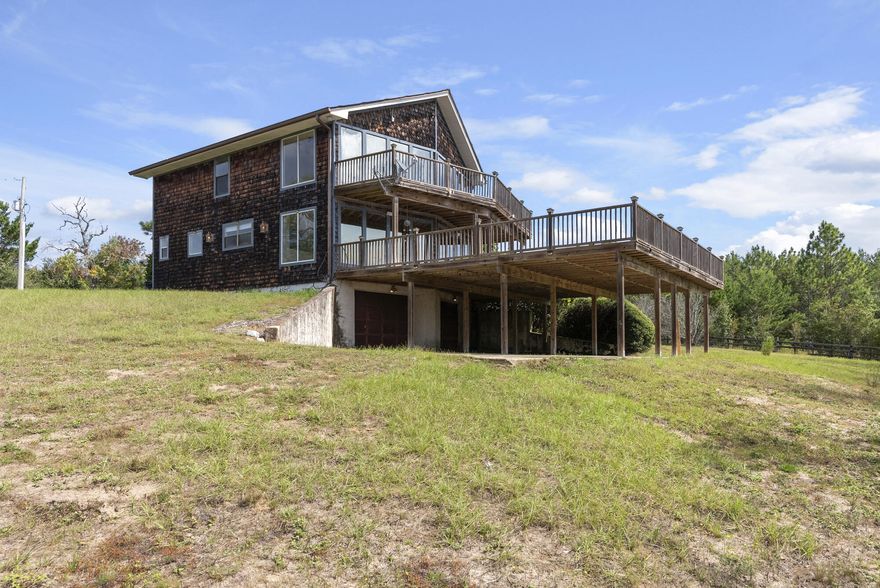 MUST SEE!  Seller just had complete interior redo of this house.  Gives this country hide away a truly ' like new' feel.  Clean, neat & move in ready. Embrace the best of both worlds, privacy and convenience, in this 2-story, 2,212 sq ft home, perfectly positioned across from Eglin AFB and its 4,480 acres.  This unique property offers daily encounters with deer, turkey, and native wildlife easy to enjoy from the comfort of your oversized walk-out deck. Property Features includes 4 Bedrooms 3 Full Bathrooms, 2212 Sq Ft of Living Space a Full Basement, ideal for storage or future expansion. An Oversized Deck with Serene Views. the house is a Classic Two-Story Design with Rustic Charm. Just 10 minutes to major shopping.