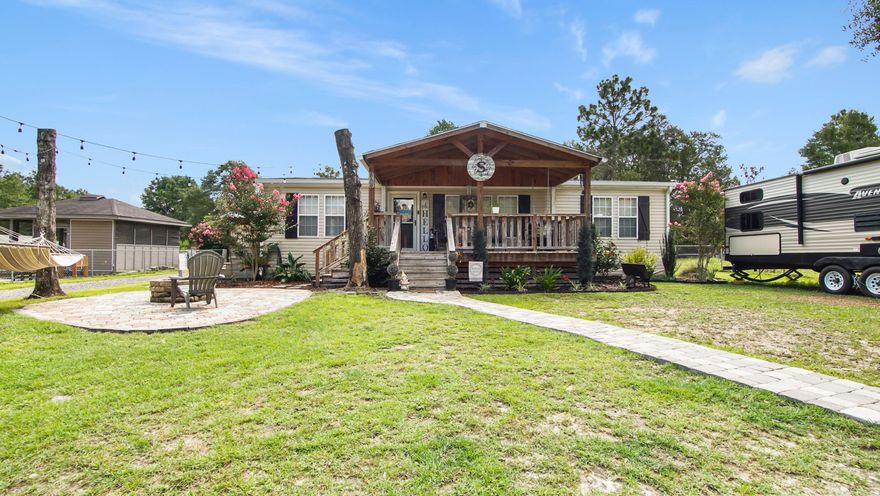 Discover comfort and convenience in this manufactured home, thoughtfully updated with custom finishes throughout. The open-concept layout is ideal for casual living, with beautifully crafted kitchen cabinets and stainless steal appliances. Enjoy fresh air from not one, but two open porches, or gather around the fire pit. A 24x24 workshop with a 10x10 guest space or office means room for hobbies. The fenced backyard provides added privacy, and the 30-amp RV hookup makes it ideal for guests to stay in comfort while visiting DeFuniak Springs. With a newer roof, it truly is move in ready.   Located just minutes from town, parks, schools, and shopping, everything you need is within easy reach.