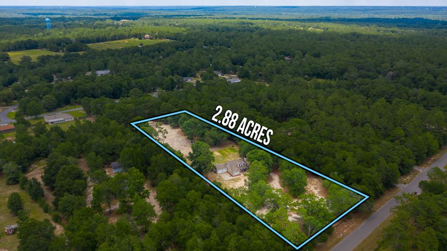 3 Acres! Adorable country charm, bring your horses and farm animals, or just enjoy the privacy! 4 spacious bedrooms, with two upstairs, two downstairs. Wood look flooring, white cabinets and dormers add to the cottage appeal. Set back from the paved road, on a quiet street in south Baker, enter to mature oaks and gated fencing. 2 car garage for the toys and vehicles, and a front porch to sip tea on a rocking chair during a lazy summer afternoon. A spacious dining room, sprawling master bedroom, and two gorgeous baths with tile floors round out the home. Need a barn? Extra large barn included! Chicken coop for the feathered friends, cross fencing and rows and rows of vegetables waiting for you to pick!