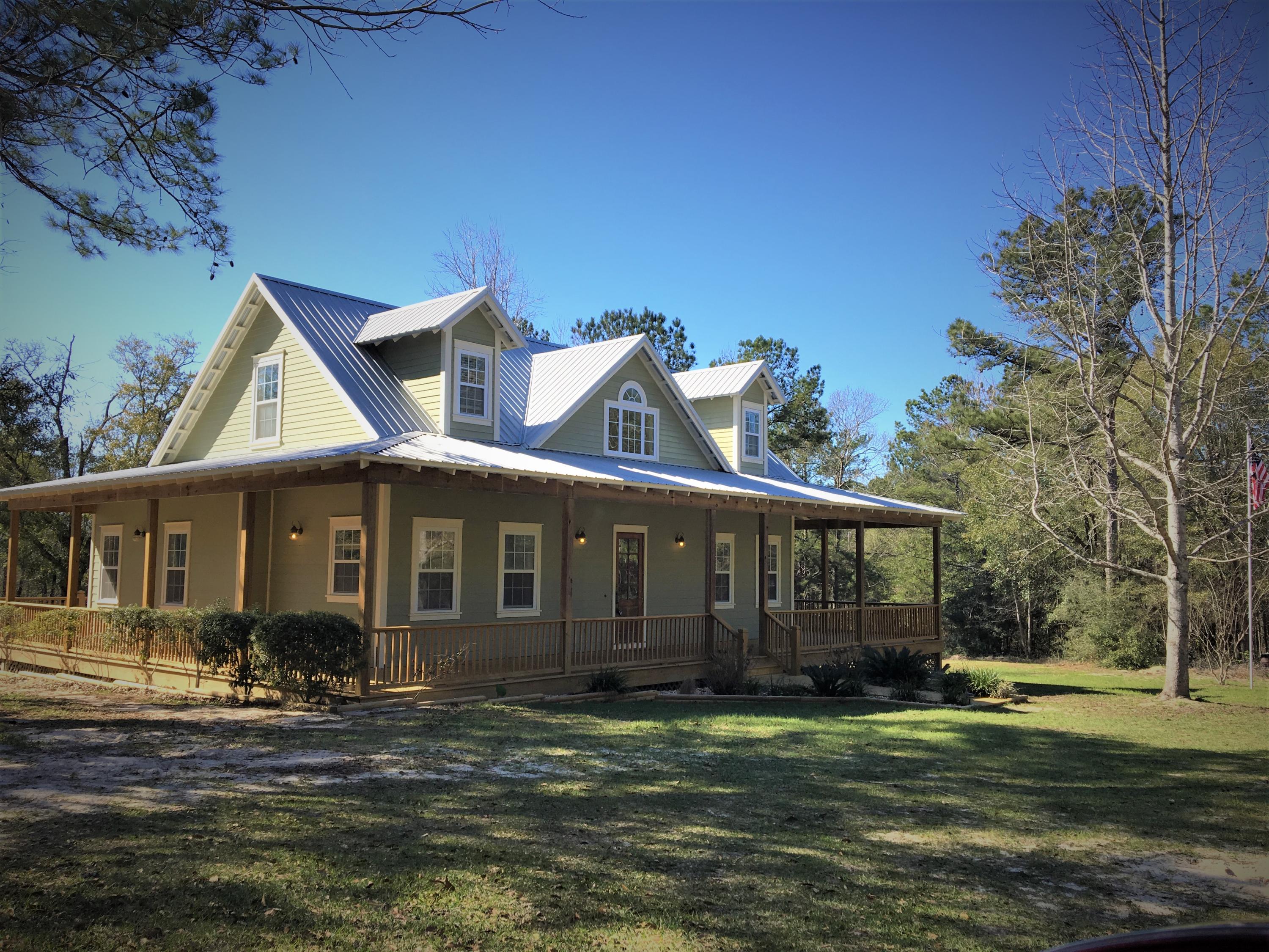 **NEW UPDATE** $3000 Closing cost assistance and Home Warranty!COUNTRY LIVING ONLY MINUTES FROM EVERYTHING AND DOING IT IN FABULOUS STYLE...This beautiful country home is set among gorgeous property with no neighbor in sight of the home! 5 Acres with a private drive and all land lines cleared with corner posts in place. The property has some of the most beautiful hills, ravines, and natural vegetation in our area. There are trails with a bench for you to enjoy the solitude and watch the wildlife. The home is gorgeous and yet warm and inviting at the same time. Upon driving up in the front yard you see the home with the large welcoming porch on 3 sides and a beautifully landscaped walk leading to the front door. The exterior is tastefully painted with a metal roo
