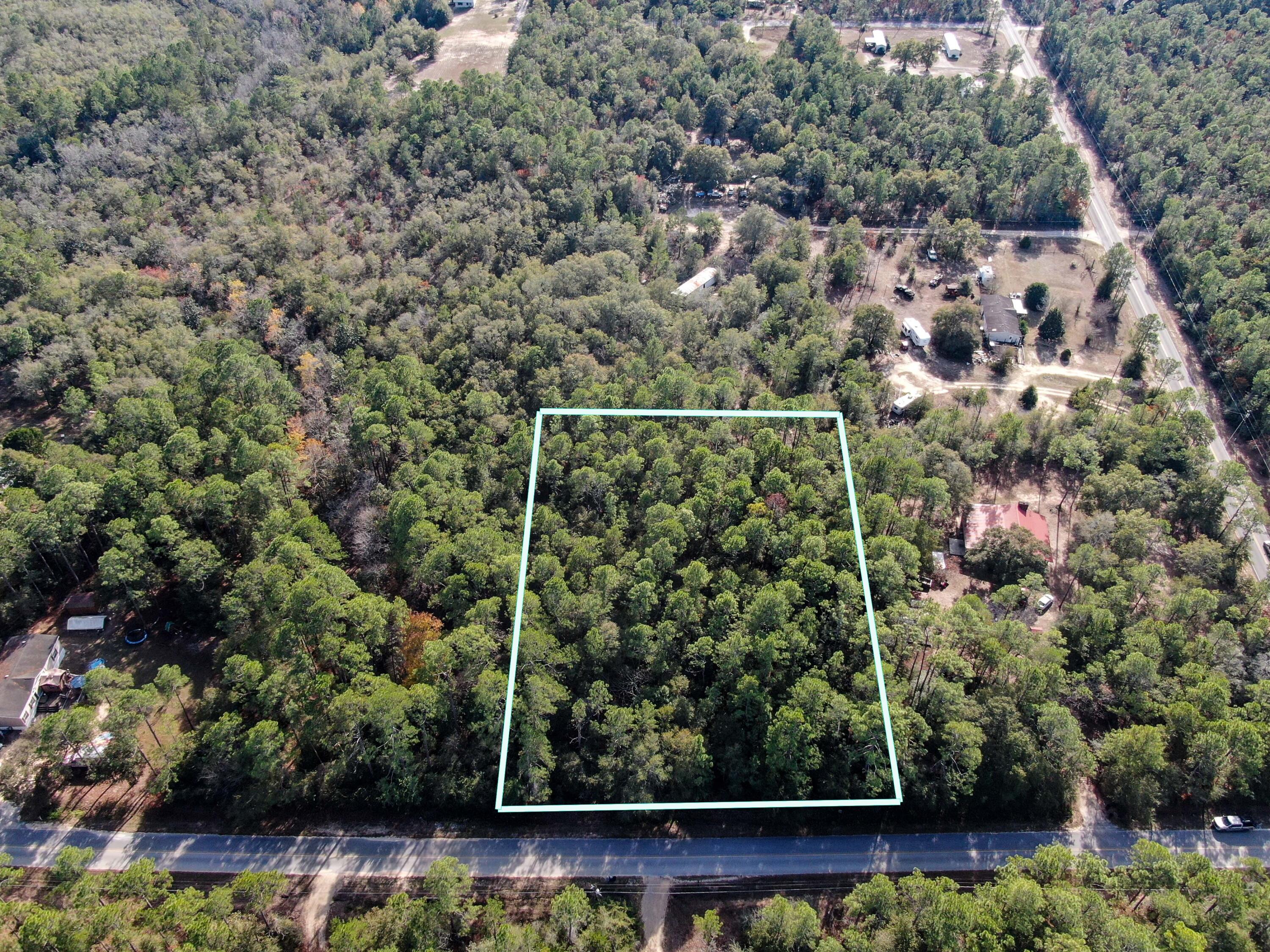 Wow! 2 acres, near the new DeFuniak Springs Municipal Airport and only 5 minutes to downtown. A mix of homes and manufactured homes in the area with manufactured homes allowed on this parcel. Property gently slopes towards a small creek on the northeast corner with plenty of room to build or place a home. Survey will be complete in a few days and the perc test recommendation for an in-ground standard system is in the documents section of MLS. City water available - tap fee has not been paid. You won't find a better value or price for this size property in the current market!