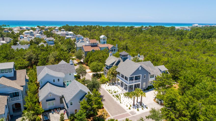 Amazing opportunity to own this unique 4 bedroom, 3 1/2 bath home in Watersound Beach! This immaculate beach home sits on a large corner lot & backs up to Deer Lake State Park, offering unparalleled privacy. This extra wide lot allows for the addition of carriage house, outdoor kitchen, pool and parking for up to 6 cars. Designed by Gerald Burwell of VIE Magazine and masterfully constructed by Dune Construction, this beautiful coastal residence is one of the most photographed homes in all of Watersound Beach. The white sand yard makes it unique to the community. Spacious wrap around porches welcome you into the entry foyer and the spacious, open concept living area. From there, the home gracefully flows into the cozy dining area and gourmet kitchen, which leads to the screened back porch.