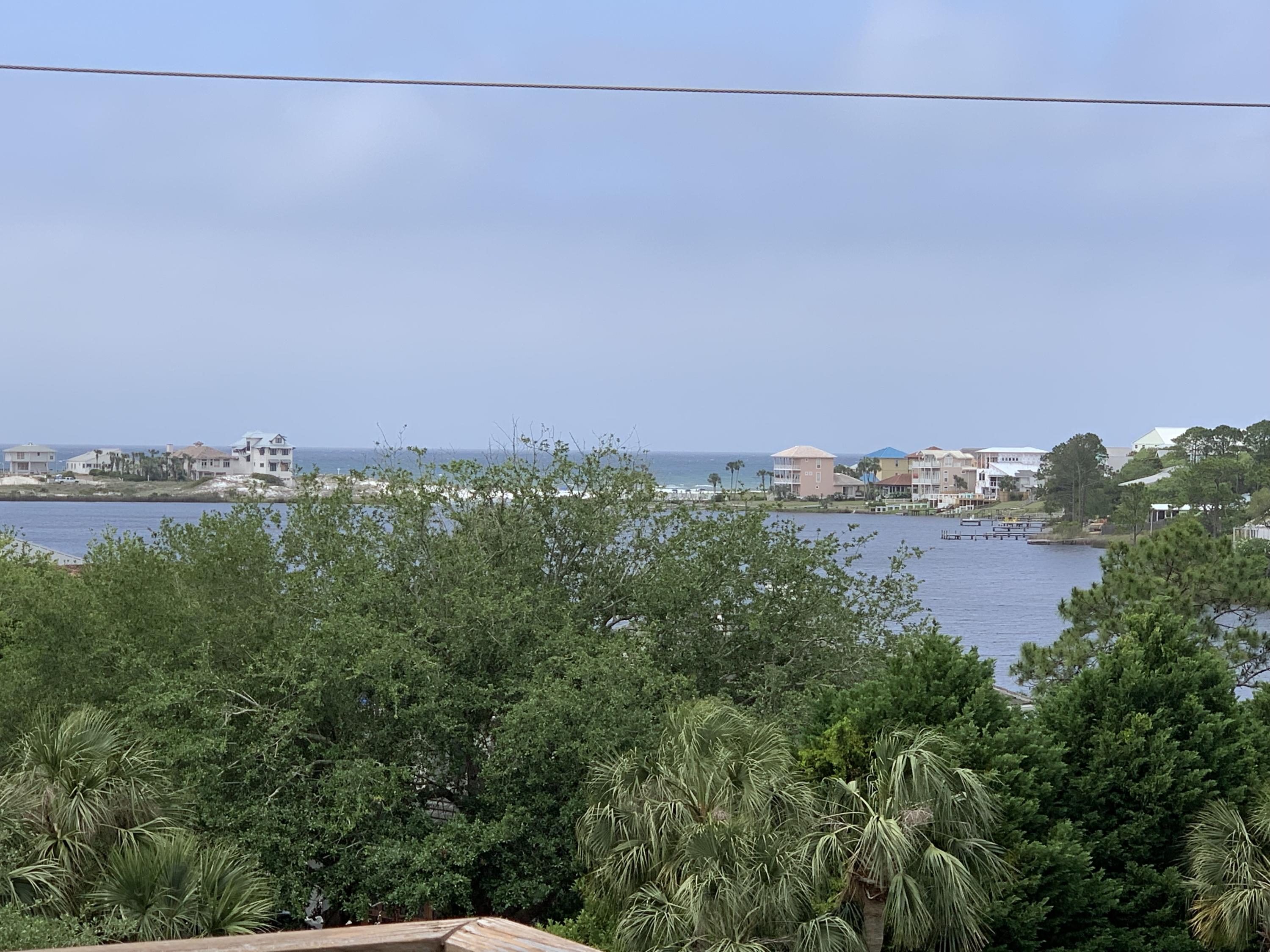 This beautiful 2 bedroom/2.5 bath condo is located directly on Scenic Highway 30-A in Seagrove Beach. Next door to Old Florida Fish House, walking distance to the white sandy beaches, and down the street from popular Seaside, this upscale condo is a great place to live or vacation! The unit is above the shops and commercial spaces of Eastern Lake Village and occupies the second and third floors. High ceilings, lots of windows, French doors galore, and beautiful finishes give a grand feel to this home. The flooring throughout is wood and travertine. The lower floor has a large foyer with stairs leading to the next level. Also on the first level is the guest bedroom with bathroom on suite and the master bedroom and on suite bathroom. Off the master suite is a spacious balcony.