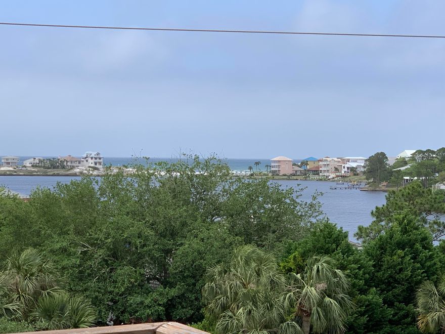 This beautiful 2 bedroom/2.5 bath condo is located directly on Scenic Highway 30-A in Seagrove Beach. Next door to Old Florida Fish House, walking distance to the white sandy beaches, and down the street from popular Seaside, this upscale condo is a great place to live or vacation! The unit is above the shops and commercial spaces of Eastern Lake Village and occupies the second and third floors. High ceilings, lots of windows, French doors galore, and beautiful finishes give a grand feel to this home. The flooring throughout is wood and travertine. The lower floor has a large foyer with stairs leading to the next level. Also on the first level is the guest bedroom with bathroom on suite and the master bedroom and on suite bathroom. Off the master suite is a spacious balcony.