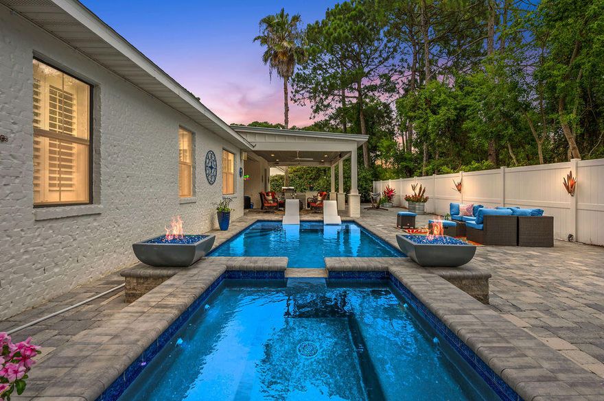 Open House Sunday 3/1/26 from 1-3pm. Amazing Curb Appeal and the Backyard of Your Dreams in this 4 bed/3bath home! All new in 2023-heated gunite pool/hot tub with fire pits, a covered outdoor kitchen with breakfast bar and an expansive patio area to entertain all of your friends and family. There is even a double gate on the side of the house for you to park your boat or camper and a heated/cooled garage! Another big perk - you are Just a quick golf cart ride to the beach at Pompano Joe's!  New hot water heater in 2025, generator and main HVAC in 2023. New roof in 2022. Inside, you will find a spacious living area, an updated kitchen, a formal dining room and an office on the front of the home. The owner's suite has trey ceilings, a fireplace and an exquisitely remodeled bath complete with a double vanity, soaker tub and a shower that is to die for. There are also two bedrooms and another full bath on the other side of the home. The 4th bedroom is located upstairs and works perfectly as a bonus/game room or art studio. It also has it's own bathroom as well. This home is impeccably cared for and is a must see in person! The extensive paver drive way and the expansive, private backyard oasis makes this home like no other on the market. This beautiful, quite waterfront community is a great place to call home. There are no HOA fees and while the homes in this area are primarily owner occupied, you can use this home as a short term rental if desired. You are 1.7 miles to the public beach at Pompano Joe's. There is also waterfront park just down the road and beautiful homes all around you. Schedule your showing today to see all this home has to offer!
