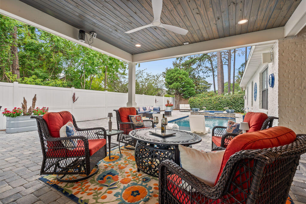 This beautiful 4bdrm 3 bath brick home has great curb appeal andTHE BACKYARD OF YOUR DREAMS!!! All new in 2023-heated gunite pool, hot tub with fire pits, a covered outdoor kitchen with breakfast bar and an expansive patio with dining area and enough space to entertain all of your friends and family. Just a quick golf cart ride to Pompano Joe's and the beach too! There is even a double gate on the side of the house for you to park your boat or camper AND a heated/cooled garage! New hot water heater in 2025. New generator and main HVAC in 2023. New roof in 2022. Inside you will find a spacious living area, an updated kitchen, a formal dining room and office on the front of the home and an exquisite owner's suite complete with trey ceilings, a fireplace and a completely remodeled bath. There is a double vanity, soaker tub and a shower that is to die for. There are also two bedrooms and another full bath on the other side of the home. The 4th bedroom is located upstairs and is currently being used as a bonus/game room and it also has it's own bath as well. This home is impeccably cared for and is a must see in person! The extensive paver drive way and the expansive, private backyard oasis makes this home easy to maintain and an amazing place to entertain. This beautiful, quite waterfront community is a great place to call home. There are no HOA fees and while the homes in this area are primarily owner occupied, you can use this home as a short term rental if desired. You are 1.7 miles to the public beach at Pompano Joe's. There is also waterfront park just down the road and beautiful homes all around you. Schedule your showing today to see all this home has to offer!