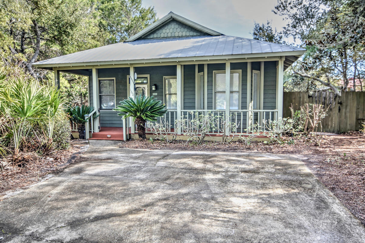 Centrally located in Seagrove Beach; this house is in an ideal location along Scenic Highway 30A. Nestled among the trees, there is a spacious side and back yard that is reminiscent of an enchanted garden. Before you enter the interior of this home, one can easily see this property is unlike any other. The side yard presents an unattached work shop and ample space to enjoy your magical outdoor paradise. An expansive covered front porch greets you as you enter the home; the front door gives way to an open living room with fireplace and vaulted ceilings, new flooring and plenty of windows with plantation shutters. Additional features include kitchen with custom cabinets, granite counter tops, separate laundry room and more. Beach access is found less than 1600 feet away from your home. Close proximity to Highway 395 and located near neighboring Seaside and Scenic Highway 30A's favorite dining and entertainment options.