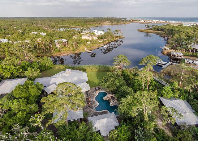 This estate is nestled in the heart of the historic and eclectic community of Grayton Beach on approx 1.4 acres. Located on nearly 200 feet of Western Lake this exceptional compound offers 4 separate buildings for comfortable living. All are shaded by southern magnolias, towering pines and moss-draped oaks. The spherical living room with a wrap around porch offers expansive views across Western Lake, to the white sand dunes and the Gulf of Mexico. Kayak, paddle board, motor or walk from your private dock to the Beach! Bike and enjoy the activities at WaterColor and Seaside then return home to entertain in your private pool with waterfalls, summer kitchen and pool house. Additional features include an exercise room, theater room, spacious master suite and office, large carriage