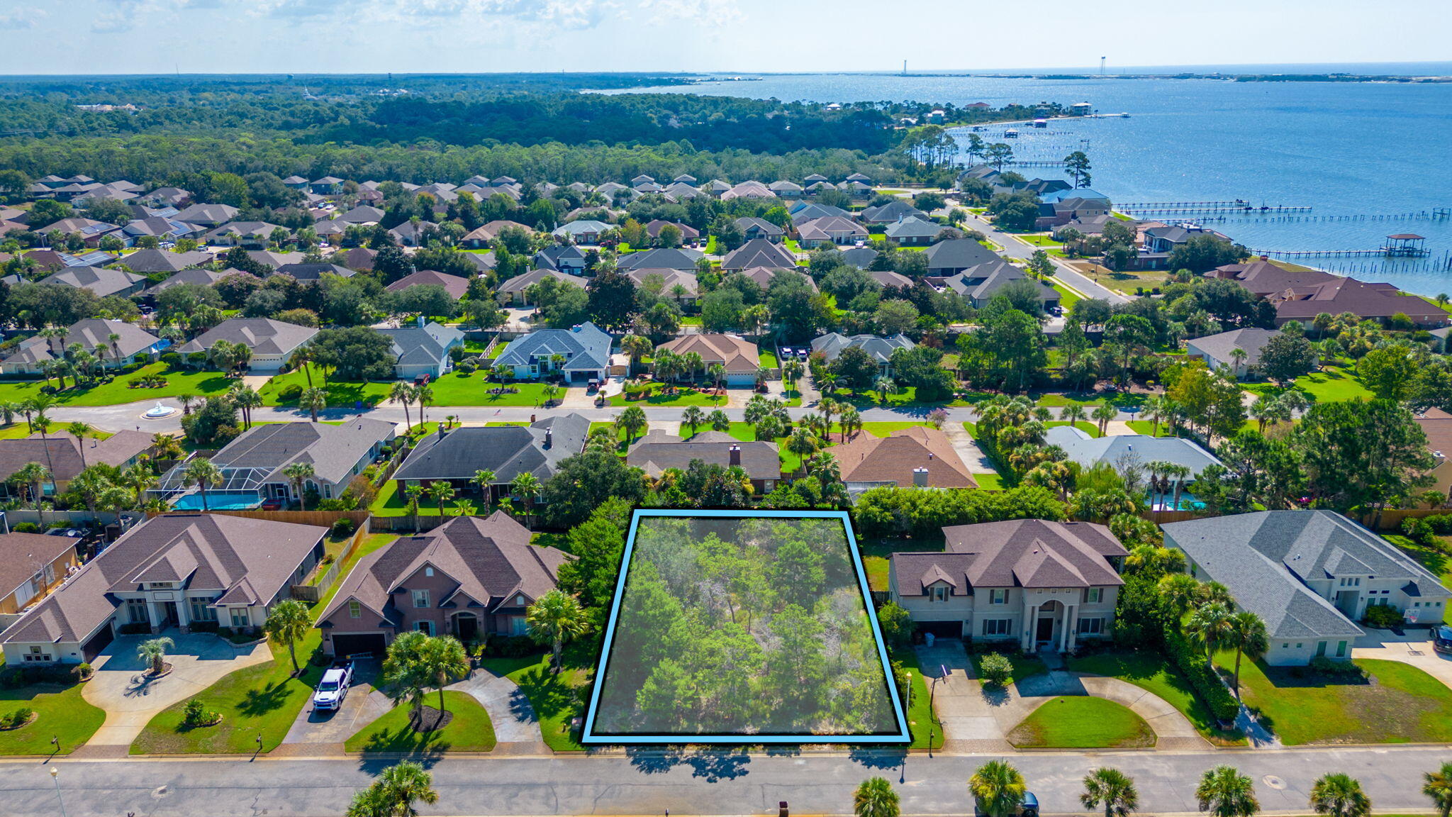 Come build your dream home on this wooded lot in the gated community of La Fontaine, where location is EVERYTHING. Fontainebleau Court is minutes away from ''Florida's Best Kept Secret'', Navarre Beach; 22 miles from the Destin and 27 miles from Pensacola. Lot is walking distance from your own slice of paradise where the community of La Fontaine holds deeded access to the Santa Rosa Sound- Launch your kayak, paddle board, or maybe catch sight of a pod of dolphins while relaxing at the community gazebo. Two separate lots For Sale. See Lot 1 Fontainebleau Court for details on second lot.