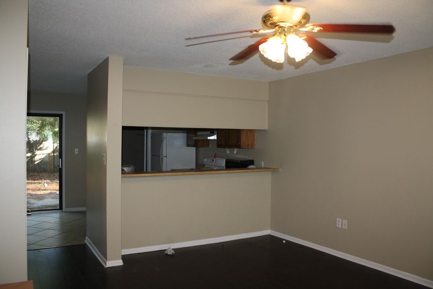 This fabulous town home features 2 bedrooms 1.5 baths. Beautiful wood laminate and tile throughout the entire downstairs. Entire town home has neutral paint. The kitchen has an electric stove, built in dishwasher, microwave, and fridge with glass sliding back doors to the backyard. Bedrooms both are carpeted with ceiling fans and nice large closets. Privacy fenced in backyard and storage shed. Has two parking spots out front.