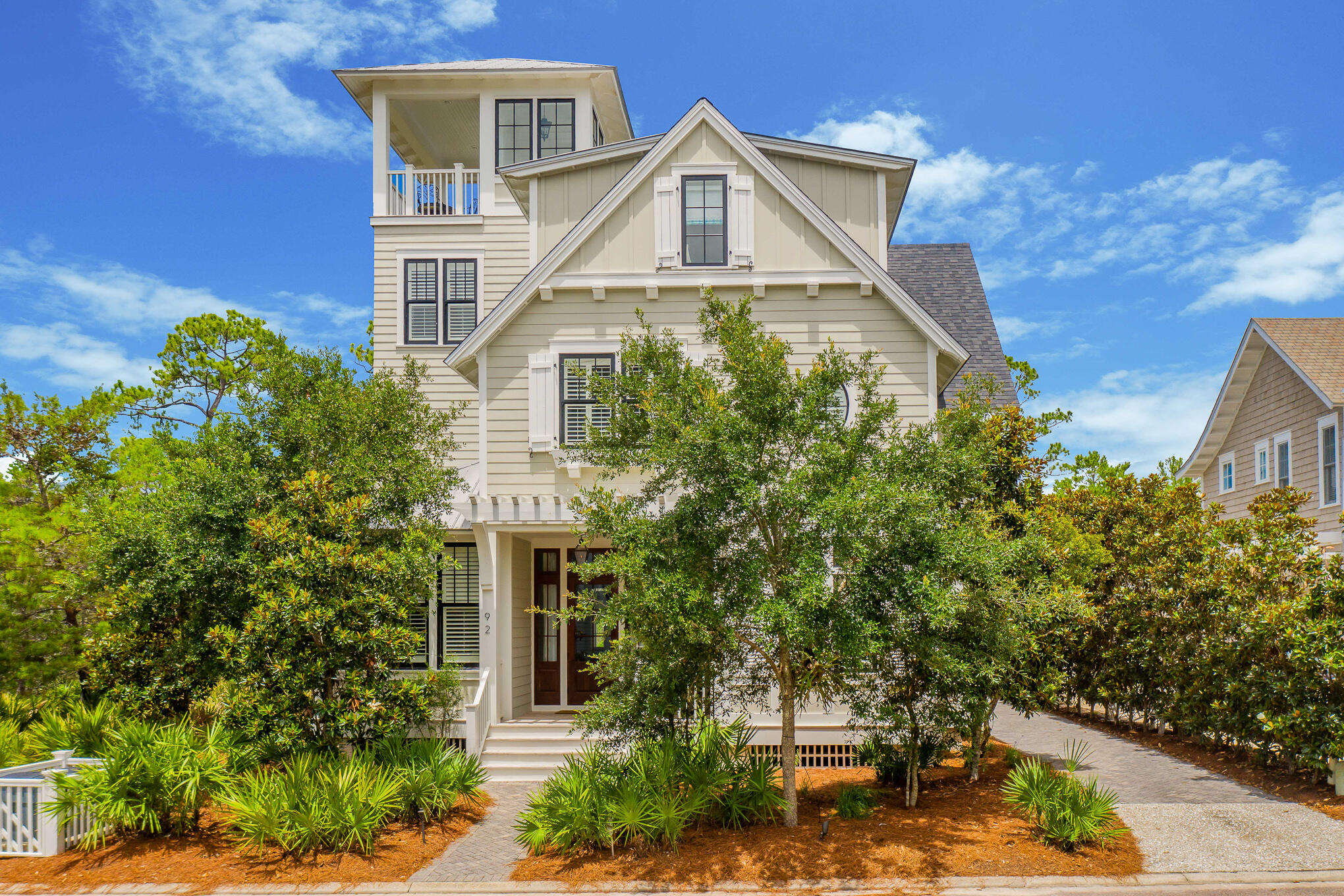 This beautiful WaterSound Beach home offers unmatched privacy in a home designed to be a personal oasis and immaculately maintained since day one. Step through the mahogany door into the entry flanked on both sides with rustic Chicago brick walls opening up into the large great room. This room is perfect for entertaining with an oversized island and dining area looking out over the backyard. The living area centers around a crushed shell fireplace with an antique beam mantle. Hand hewn beams criss cross the ceiling and shiplap lines the walls. Open the french doors and enter the backyard oasis with a deep porch and large pool and spa overlooking Deer Lake State Park. Privacy is key here with nothing but nature behind you. This level is also home to an office, powder room and master suite.