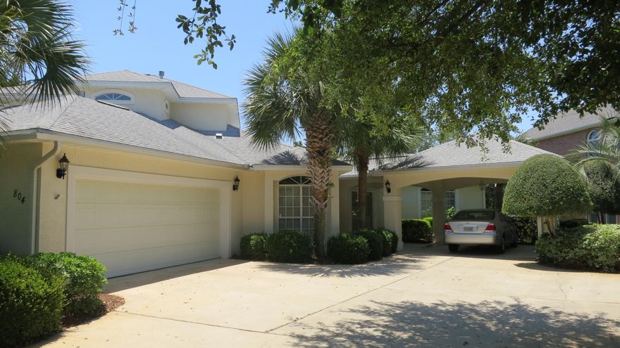 This is waterfront living at its finest! Enjoy the protected area of the lake yet with easy access to the bay for all of your boating needs. This beautiful well kept home has everything you need, with wonderful views from your living areas, kitchen, master, and the large deck. Two living areas are optimal for entertaining, with one of them open to the kitchen and exterior deck. Features include a seawall, built in 2005, dock, wood and tile floors, stucco redone in 2011, 2 AC units - 1-2 years old, Centricom termite system, new lights and fixtures in bathrooms. There are 2 bedrooms downstairs, one can be used as an office, and 2 upstairs, off of a loft area, which can be used as an office or childrens play area. The beautiful landscaping features mature magnolias, azaleas and palm trees.