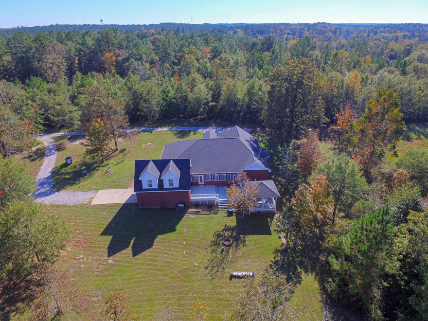 Large Estate brick home on 10 acres! Minutes from Downtown Defuniak Springs yet in the country on your own 10 acres. 3902 square foot heated/cooled brick home with 6252 square feet including garages and porches. Featuring 4 bedrooms including a huge master suite with gorgeous views of your property and 2nd floor bonus master suite. Built in 2006, the gorgeous and spacious kitchen has all stainless steel appliances, breakfast island with white farmhouse sink and ample dining space including a built in bench for extra sitting for a large family kitchen table. Huge family room with wood look tile floors, 17 foot wall of bookcases, gas fireplace, large screened room with sink for easy entertaining and great deck with beautiful gazebo. The rolling 10 acres features a creek running the (click)