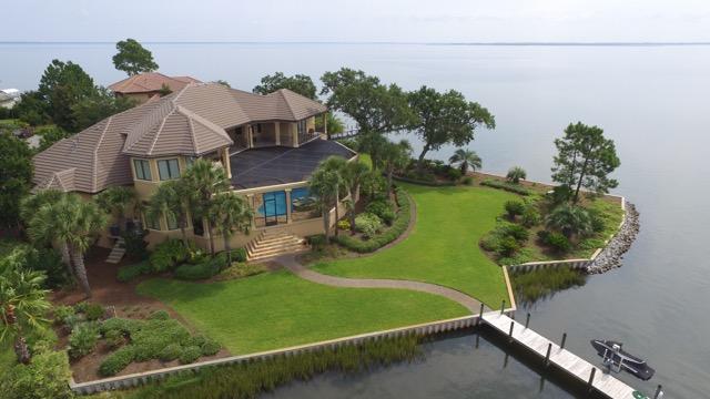 Stunning waterfront location in the gated community of Grand Cove in Santa Rosa Beach. Privacy and gorgeous views over Honeymoon Cove highlight this property located at the end of a cul-de-sac. Built in 2005, with hurricane glass and doors, this estate offers an open floor plan with breathtaking views from almost all areas of the home. The home is in immaculate condition and the interior was just repainted. The billiard room could be a 4th bedroom. The 70' dock with covered boat lift and jet ski ramps are perfect to extend your fun onto the water.