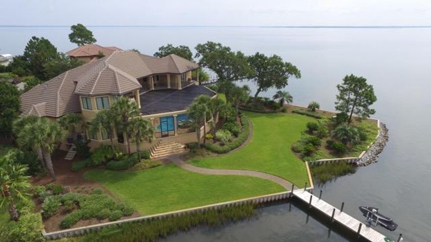 Stunning waterfront location in the gated community of Grand Cove in Santa Rosa Beach. Privacy and gorgeous views over Honeymoon Cove highlight this property located at the end of a cul-de-sac. Built in 2005, with hurricane glass and doors, this estate offers an open floor plan with breathtaking views from almost all areas of the home. The home is in immaculate condition and the interior was just repainted. The billiard room could be a 4th bedroom. The 70' dock with covered boat lift and jet ski ramps are perfect to extend your fun onto the water.