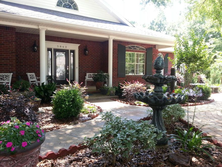 COMPLETELY remodeled and updated, this lovely home is better than new. Everything is new starting with the front door! Schedule your showing today and find out why people always stop in front of the home to admire the landscaping and ask to see the yard! This home has been redone inside and out, curb appeal galore, designed for easy maintenance. The home features updated AC, all new flooring throughout the entire home, interior additions, new cabinetry, lighting, granite counter tops, custom shower doors, faucets, hardware, all stainless appliances, subway tile, crown molding, French doors, whole home gutters, new pantry addition, sunroom addition,and the new R-44 Insulation. Wonderful split bedroom layout and beautiful kitchen with island and undercabinet lighting.New lighting throughout