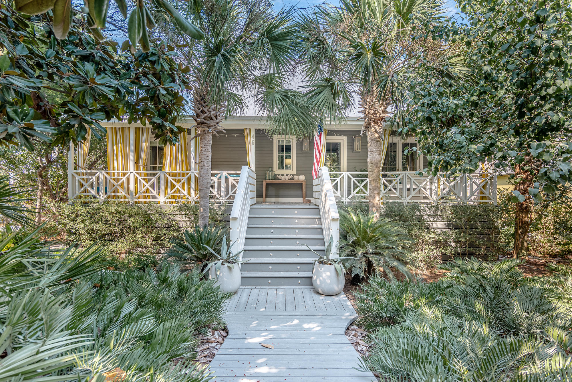 Don't miss the opportunity to own this gorgeous Old Seagrove cottage that was featured as the Coastal Living Magazine Idea Home in 2015. The cottage has been completely transformed to be the ultimate Caymen Island-inspired getaway, while keeping with the character of this timeless 30A neighborhood. The original renovation was completed by Peter Horn of Artisan builders along with architect Mark Schnell, and designer Paige Schnell of Tracery Interiors. 2019 brought further innovations to the home, making it even more functional as a full-time residence while keeping the island-style charm.Lush landscaping across the lot provides privacy while a charming front porch with custom handrail and gas lanterns welcomes you into this one-of-a-kind property.