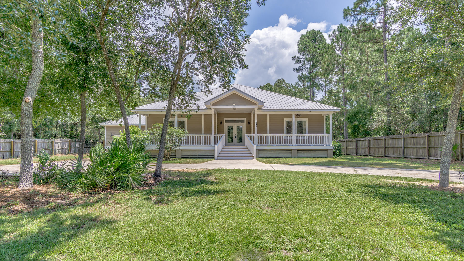 Newly renovated Florida cottage nestled among mature trees with a water view of Mallet Bayou! Home offers amazing views,privacy and style. Enter into the elegant great room with high ceilings,tons of natural light and fireplace. Spacious Master offers tons of light by day with beautiful views.Master bath has double vanity, jetted tub and tiled shower-complete with rainfall shower, body jets and wall shower head.Kitchen includes granite counters,solid cabinets and new appliances.All Bedrooms offer beautiful views, lots of natural light & huge closets. Closet lights turn on when doors open.Circular drive-perfect for your boat or RV and guests.You'll love the outdoor living with 600 sq ft rocking chair front porch as well as 500 sq ft of screened porch all on massive lot with room for a pool.