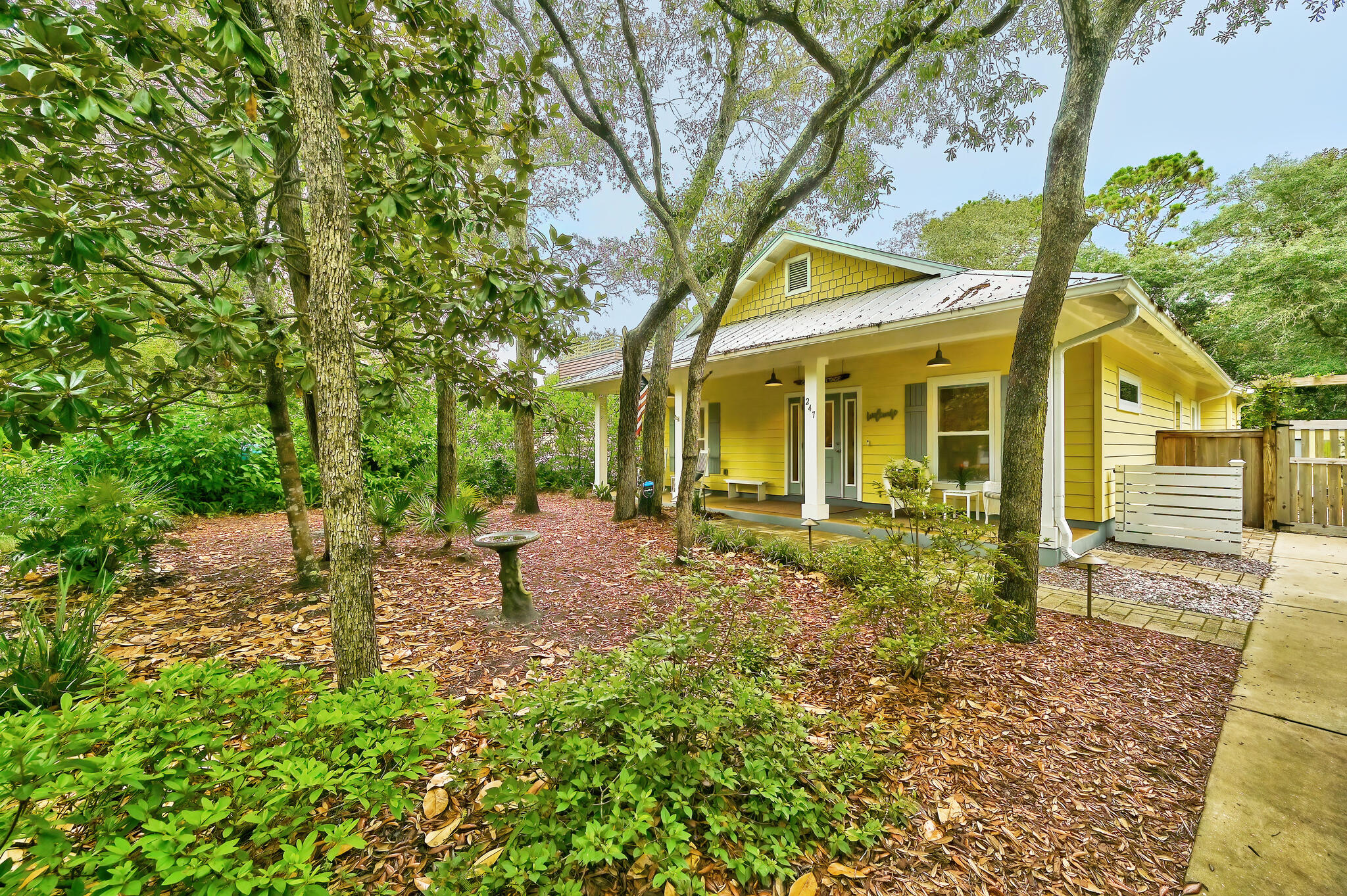 Rare Opportunity! Looking for a hidden gem on the West End of 30A? This beautifully maintained Old-Florida cottage is conveniently located on a quiet street in Beach Highland and is just a short walk away to 3 public beach access points. So close that, on a windy day, you can hear the sounds of waves crashing on shore as you relax on your front porch. Perfect as a primary, secondary or investment property, no HOA, with breathtaking outdoor living space. Amazing fenced in yard and back-in screen porch. Sold furnished (some exclusions). You will love the open floor plan and gas fireplace. Awesome stained concrete flooring throughout. This cute cottage was build by renowned builder John Willis Homes. Large kitchen and living space with custom build-in book shelve.