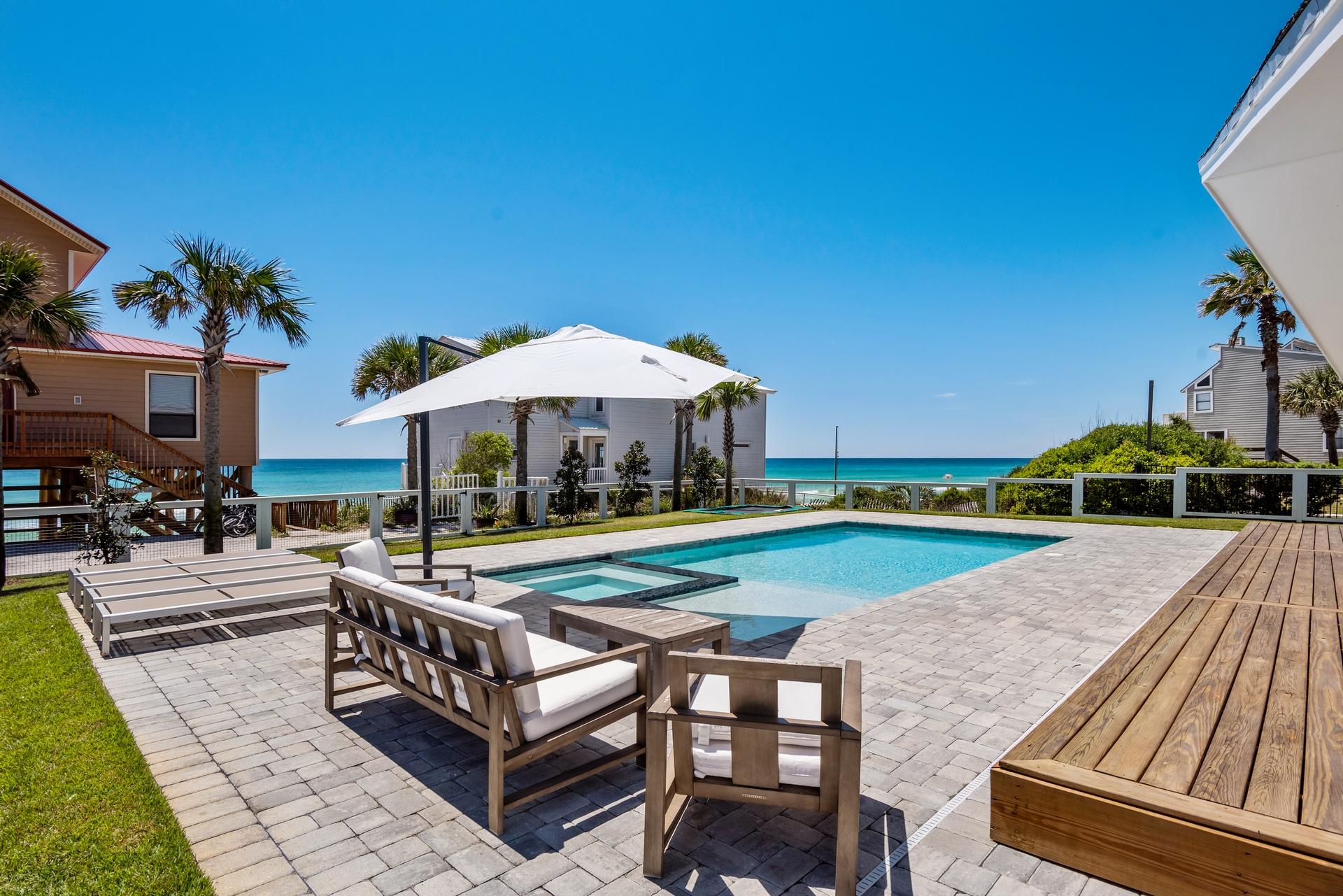This Coastal Oasis is the Perfect Beach House! This home was completely redesigned with no features overlooked. Upon entering, you will be greeted by the turquoise blue water and wide open floorplan. The Kitchen is a chefs delight with a gas Viking range, quartz countertops and Custom Cabinets complimented by the hand scrapped oak floors. The Master suite features a stand alone tub and tile shower. Situated on an oversized third of an acre with Manicured Landscaping you are offered the Rare view of both Coastal Dune Lake Views on the Front porch and Forever Gulf views in the back. The Backyard is so gorgeous you have to see it to believe it . Featuring an oversized pool , In-ground trampoline and Porch that is perfect for entertaining or Relaxing with the Family.