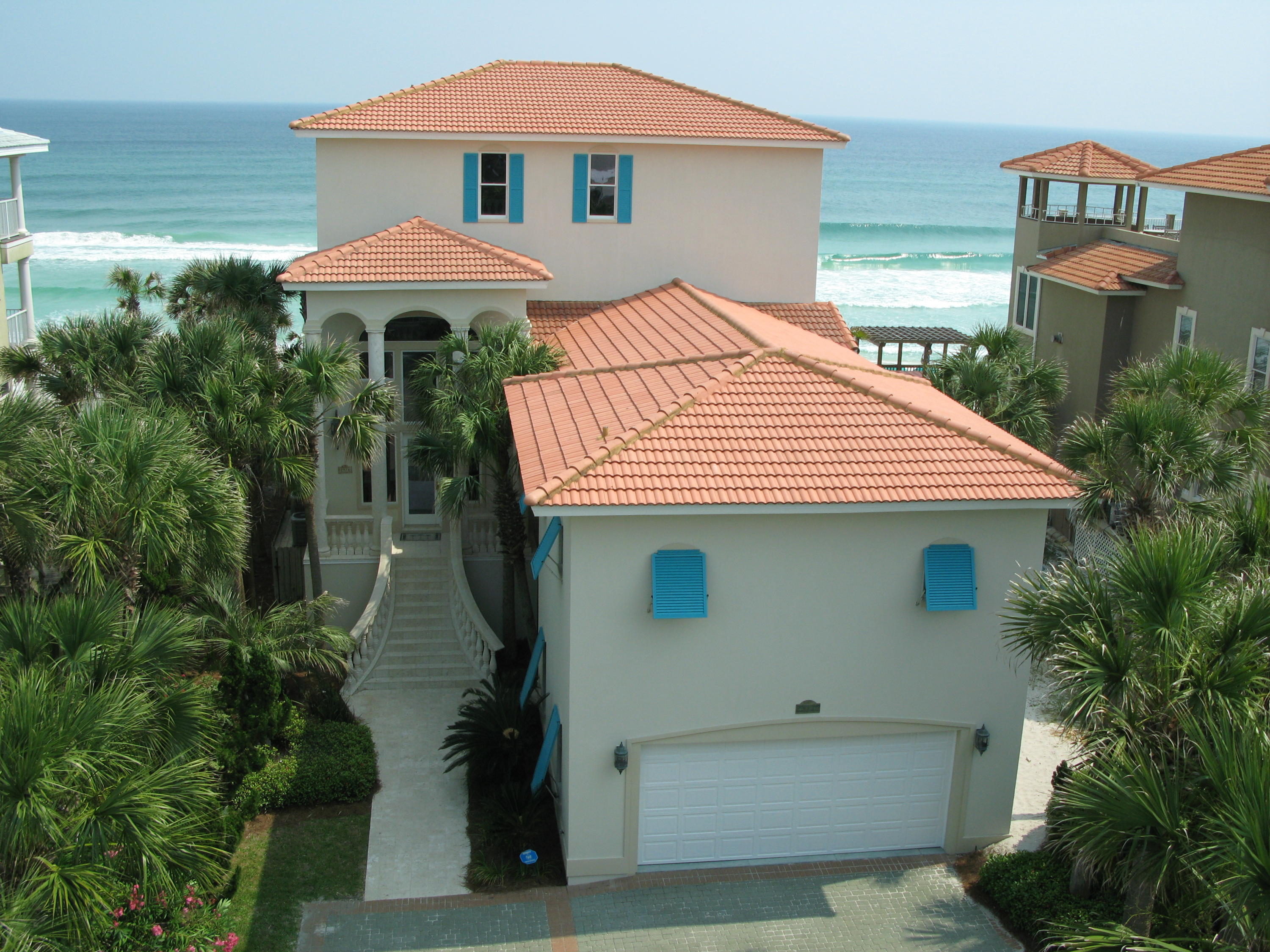 PRICED TO SELL! MOTIVATED SELLER HAS JUST REDUCED AND IT WON'T LAST LONG! Fabulous custom home directly on the sugar white sand beaches of the Emerald Coast in desirable Crystal Beach. Situated on 67 feet of beachfront, this could very well be the perfect beach house! A well though out floor plan, finely appointed with 10 foot ceilings throughout, Mexican limestone floors, marble baths and counters, granite kitchen counters and bar, crown molding, recessed and art lighting. Professionally decorated with a bright, Caribbean flair, Casa de Palmas is a tropical oasis, with lush landscaping and over 50 swaying palm trees and an impressive grand entrance of cast stone tile, columns and balustrades. From the entrance foyer catch your first view of the emerald green waters of the Gulf