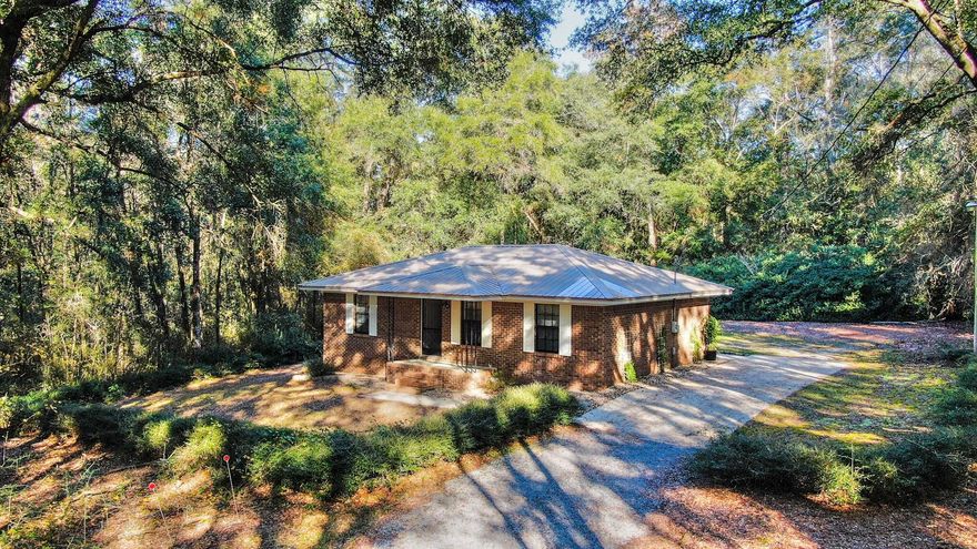 Tucked away, this downtown hideaway makes you feel like you've stepped into a far-away forest with a canopy of oak trees all around. With one original owner, this 2 bedroom 1 bath all brick home has been excellently maintained. This would make an ideal downsizing or first home. You'll find a spacious eat-in kitchen with lots of counter space and a large living room. The screened back porch is perfect for quiet mornings or evenings. The metal roof was installed in 2010 and roof was completely re-screwed in December 2021. A new HVAC in 2019 and new septic/drainfield in 2020 and newer laminate floors as well. This cute place could easily be updated, and without breaking the bank. Only a short walk to Lake DeFuniak and to the downtown area, enjoying all it has to offer.