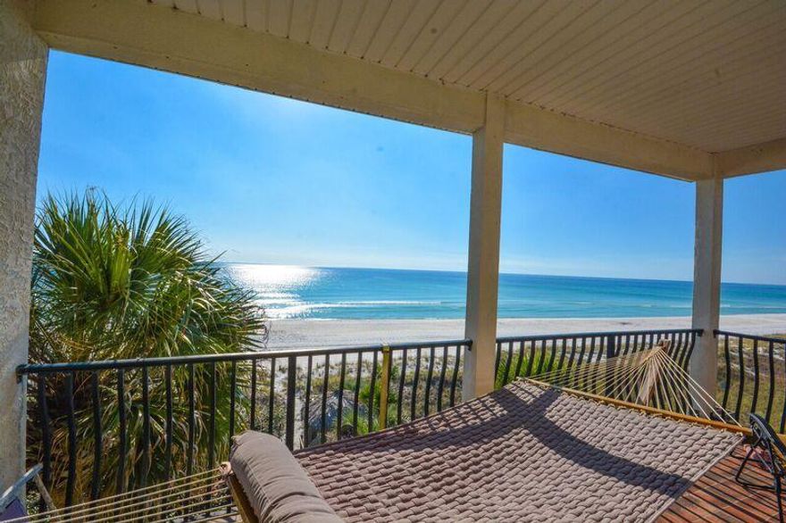 Located in a quiet setting at the West end of Front Beach Rd, this custom built home with elevator offers endless views of the Gulf and a level of privacy seldom found at the Beach. To the West is a 368' private beach park for the residents of Sunny Side Tennis Resort that affords incredible coastline views. Relax outdoors on any one of the multiple balconies or slip away onto the deck sugar white sand via the private walkover. Inside is a host of dramatic architectural features, including walls of windows and glass doors bringing the breathtaking Gulf views in. The living room is a perfect blend of casual elegance and style with raised ceilings,tall glass windows and doors for natural lighting, tiled floors, gas fireplace and sitting and dining area opening to a deep covered porch.
The Gourmet kitchen features  ample storage and counter space, an island and breakfast bar. 
The second level features  a large bonus room with Gulf views and wet bar, an impressive master suite with spa like bath and the sound of the gentle waves from a private balcony. Additionally, there are three guest rooms with private baths and a laundry room.  This is a family beach retreat for the ages. It's convenient West end location is an easy drive to Scenic Hwy 30A, Pier Park and the airport.  The adjacent home is also for sale and offers a similar floor plan. See MLS 743336.