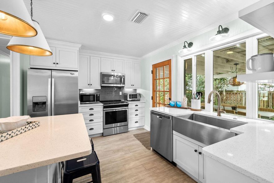 This quintessential Florida cottage enjoys a great location close to several restaurants and easy access to Blue Mountain Beach. The whitewashed exterior oozes charm while indoors the open-concept living room is brimming with home comforts. Tasteful designer accents add a touch of character to this tastefully updated space which boasts custom lighting, updated windows and eco-friendly solar panels on the metal roof. The kitchen is a culinary hub with quartz countertops and high-end stainless appliances including a wine fridge. The laid-back living area flows outdoors into a private rear yard with a barbecue grill. Head over to the quartz-topped island tiki bar where stools are lined up for morning coffee or cocktails, depending on the hour. A pergola and mature trees provide the perfect shady setting for alfresco dining, entertaining and relaxing. A bubbling hot tub, outdoor shower and a cozy chiminea fireplace round off this private backyard oasis, which makes the perfect retreat. Bedrooms are fully equipped with smart TVs to complement the flatscreen TV in the living room. The cottage includes a king-sized master bedroom with an ensuite bathroom, a second guest bedroom and a bunk room with full-over-full-sized bunks. A laundry room and parking for three cars round off the amenities. This well-located beach cottage easily sleeps eight as a vacation home or investment. Tucked away from the main flow, and near cafes and boutiques lining nearby 30A. Culinary delights ranging from Shunk Gulley Oyster Bar to artisan ice cream are all within easy strolling distance. Twenty-two miles of bike paths are made for exploring while Grayton Beach State Park and Western Lake offer endless outdoor recreation closer to home.