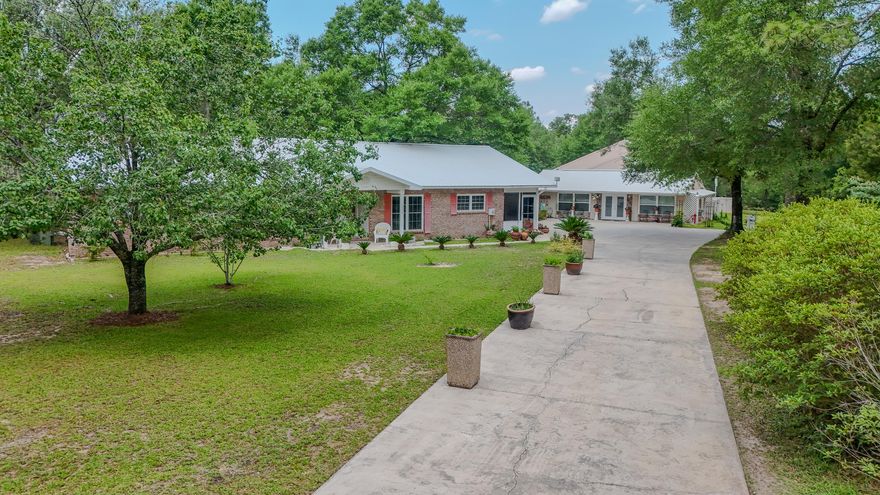 Welcome to Monarch Ranch in Grassy Pond Ranches: Private Oasis with Two Homes, Equestrian Access and Endless Possibilities! Escape to your private 9.8-acre sanctuary on Grassy Pond, featuring two meticulously maintained homes, a versatile barn, and over 300 feet of waterfront on spring-fed Grassy Pond! This unique property offers the perfect blend of luxurious living, practical amenities, and abundant space for recreation or even a small farm. The main residence, custom-built by a builder as his personal home, boasts 2,496 sq ft of thoughtfully designed living space. This 3-bedroom, 2.5-bathroom home offers incredible flexibility with abundant storage throughout (seriously, closets everywhere!). You'll appreciate the convenience of two water heaters in the main house, ensuring a consistent hot water supply. The chef's kitchen is a culinary dream, equipped with a wall oven, cooktop with a custom vent hood, and custom cabinetry with all the bells and whistles - you'll want to explore the pantry, it's a ''WOW''! Enjoy indoor/outdoor living on the wrap-around porch, perfect for entertaining and taking in the serene surroundings. The formal dining room can easily serve as an office or an additional bedroom, adapting to your needs. A convenient half bath and laundry room are located near the back door. Just steps away, the charming 960 sq ft guest house provides comfortable accommodations with an efficiency kitchenette, a large great room, a spacious bathroom with a walk-in shower, and a huge bedroom. This adorable retreat also features great storage, an 8x40' lean-to, and a tankless on-demand water heater for efficient hot water whenever needed. The impressive barn/detached garage offers incredible utility, currently accommodating 4 cars and an RV or boat with each bay measuring 12x36' and featuring roll-up doors. A 14x36' carport provides additional covered parking. Inside the barn, you'll find a climate-controlled 9x10' office. For those with agricultural aspirations, the garage can easily be converted into a livestock barn, or the lean-to area could be transformed into stalls. A fenced area around the barn is perfect for pets. Located in Grassy Pond Ranches, a sought-after community known for its numerous equestrian farms, this property offers an unparalleled opportunity for horse enthusiasts. With a private gate providing direct access to the Washington County Water Management District, you'll have miles and miles of trails right at your fingertips. This property would be an absolute dream for someone with horses who desires the opportunity for extensive cross-country riding. This exceptional Monarch Ranch is more than just a property; it's a lifestyle. Imagine hosting unforgettable gatherings, enjoying peaceful lakeside mornings, or pursuing your farming and equestrian dreams. Don't miss this rare opportunity!