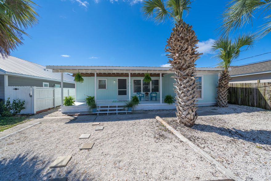 This three-bedroom Beach Home is nestled in the desirable Holiday Beach Community and is just a ten-minute walk away from the sandy beach. The covered porch is perfect for entertaining. This classic beach home would make an ideal family retreat, second home, or investment property. Short term rentals are allowed, currently grossing approximately $38,000 a year. The large sand yard is completely privacy fenced. The kitchen is updated with stainless steel appliances, rich gray cabinets with tile accent wall that opens to the living area. The master bedroom has an oversized closet and a master bathroom. There is also a separate laundry room. Golf cart friendly community with great schools and 1 block from public boat ramp into Grand