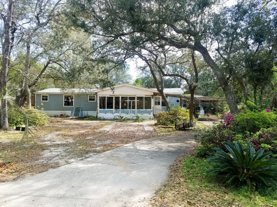 Very spacious 2BR/2BA with spilt floor plan. 3rd bedroom has been turned into a den (still has double closets). Huge dining room/living room combo with wood burning fireplace. Kitchen has breakfast nook and large pantry. Laminate flooring throughout home. Garden tub in master bath along with double vanity, his & her closets, and separate shower. Built in desk for all your office needs located off kitchen. Nice size laundry room with cabinets. Very spacious Florida Room on front of house. Ceiling fans throughout home. HUGE deck off den. Yard shed included. Black Creek Lodge (Marina) is less than 1/2 a mile from property! Perfect for starter family or investment property. Property being sold AS IS.